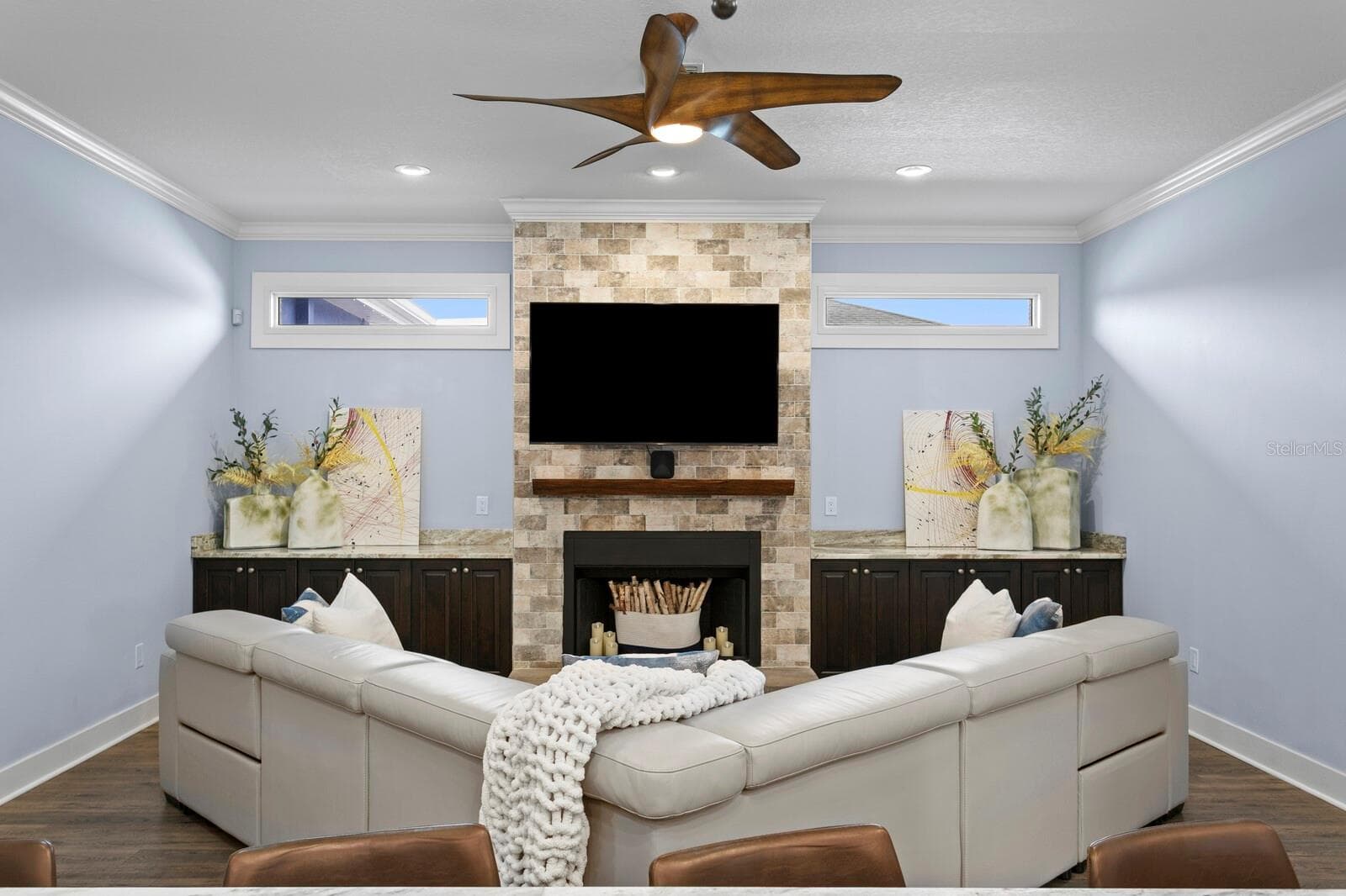 Family Room features dual transom lights, wood burning fireplace, and granite counters - 704 EAGLE LN, APOLLO BEACH