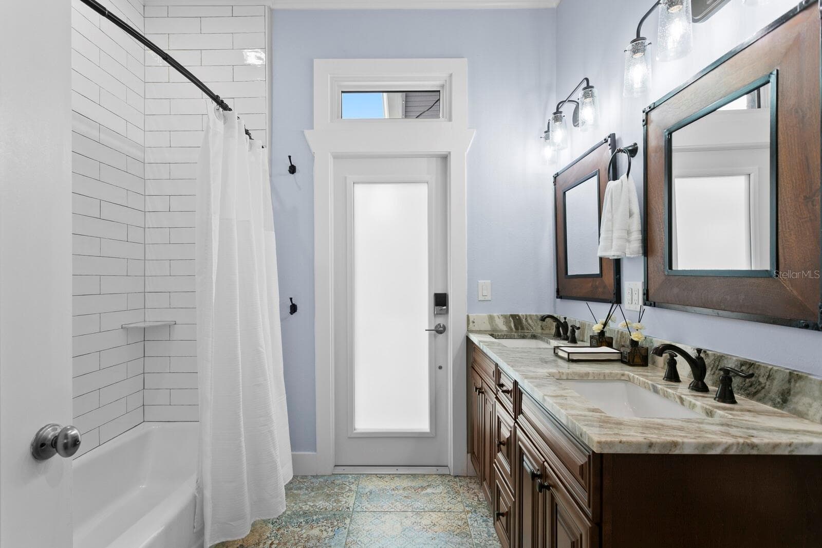 2nd Bathroom/Pool bath with ceramic tile floor, granite counters and door leading to pool - 704 EAGLE LN, APOLLO BEACH