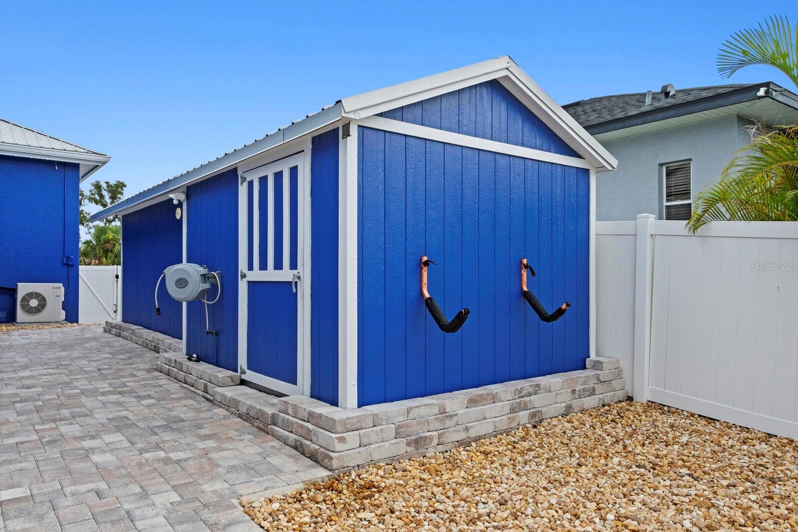 Large storage shed is attached to workshop which includes electricity and air conditioning - 704 EAGLE LN, APOLLO BEACH
