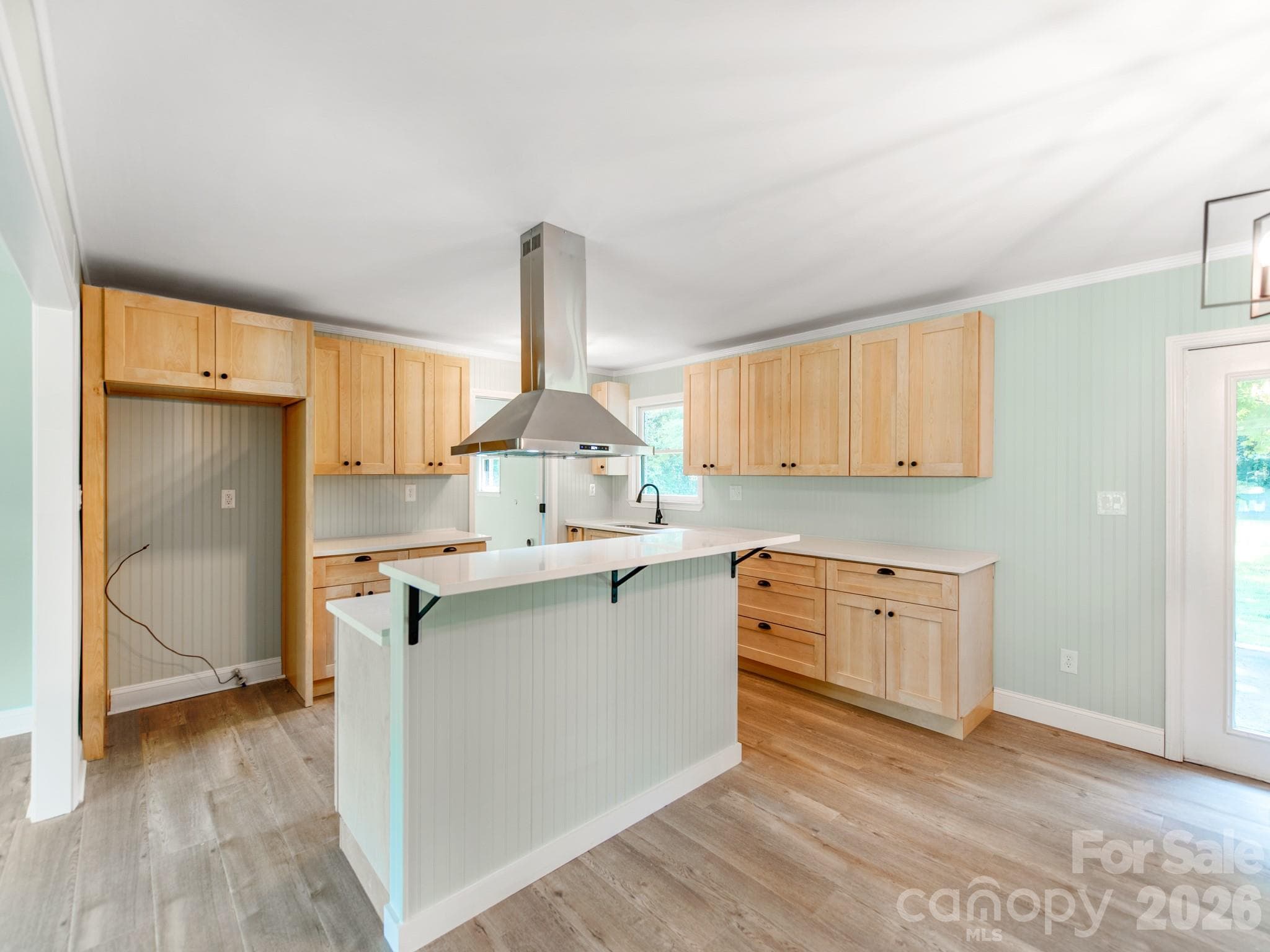 Kitchen island with new stove and vent hood - 3072 Bethany Street, Claremont