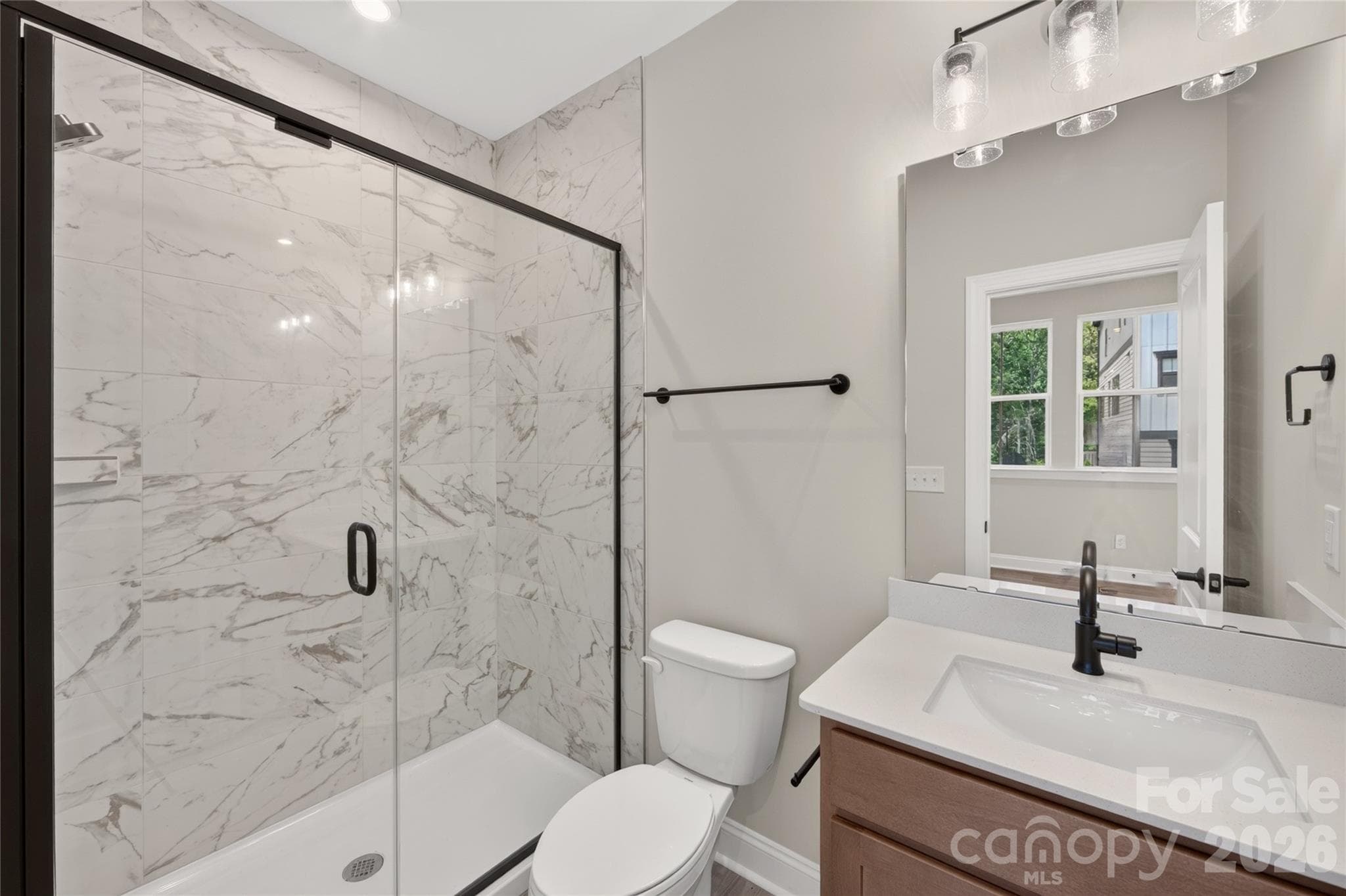 Full-tile walk-in shower creates a clean, polished look - 403 Old Town Village Road, Waxhaw
