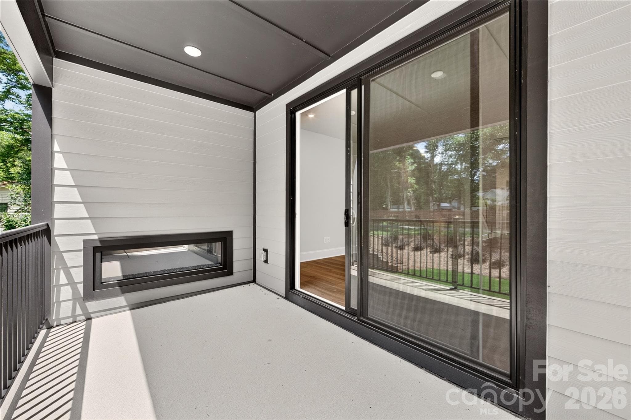 Electric fireplace creates a cozy outdoor retreat - 403 Old Town Village Road, Waxhaw
