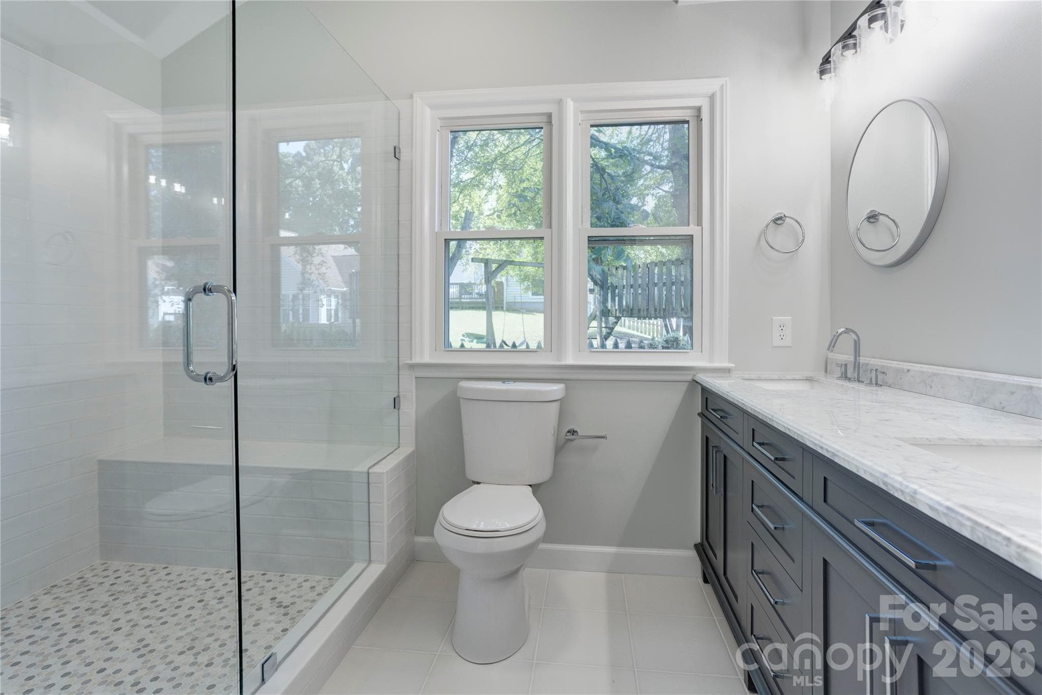 Primary bath with newly updated shower, flooring, lighting & double vanity - 156 Edgewater Drive NW, Concord