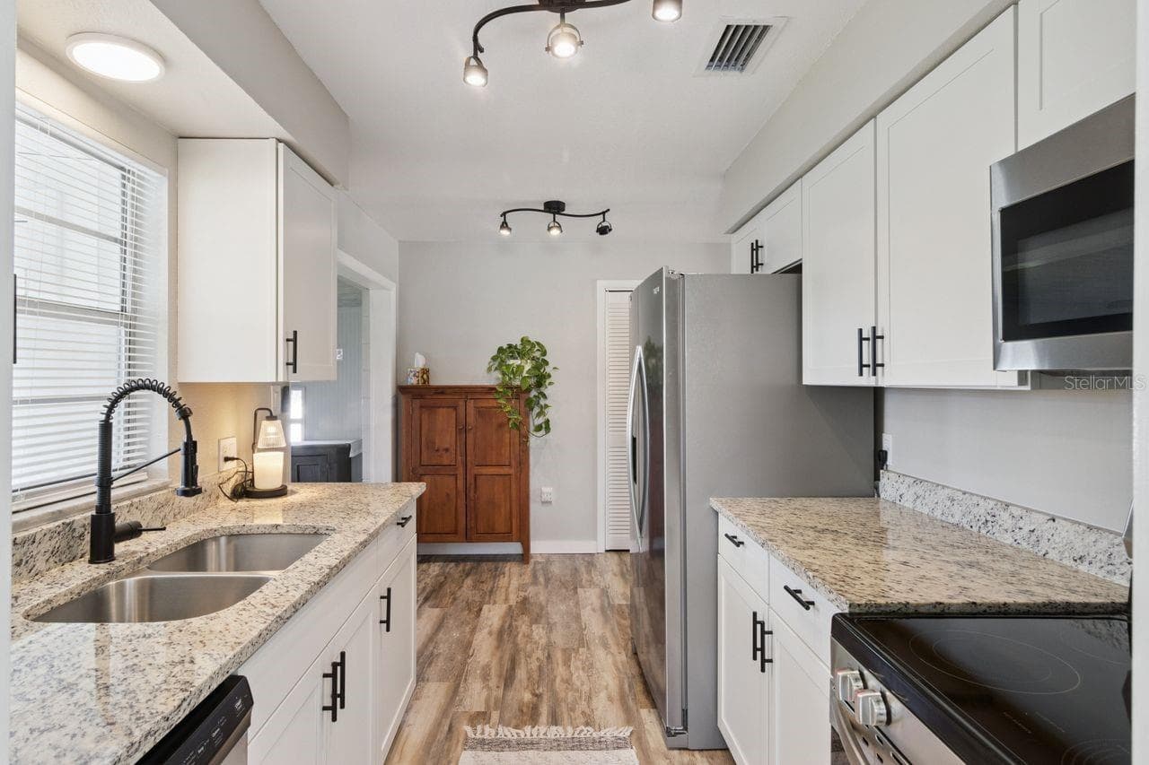 Galley Kitchen with granite counter tops and stainless steel appliances - 220 ALDO DR, BABSON PARK