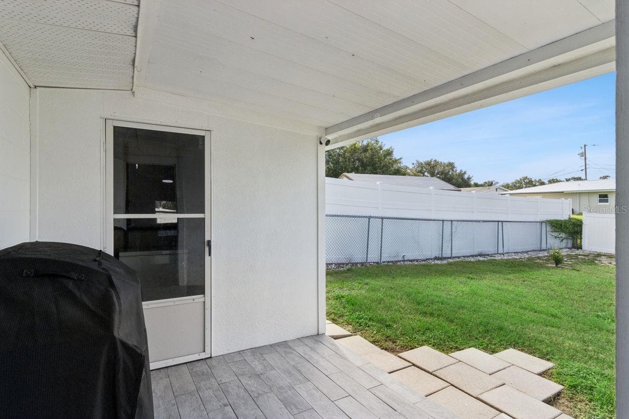 Covered porch in back with storage area - 220 ALDO DR, BABSON PARK