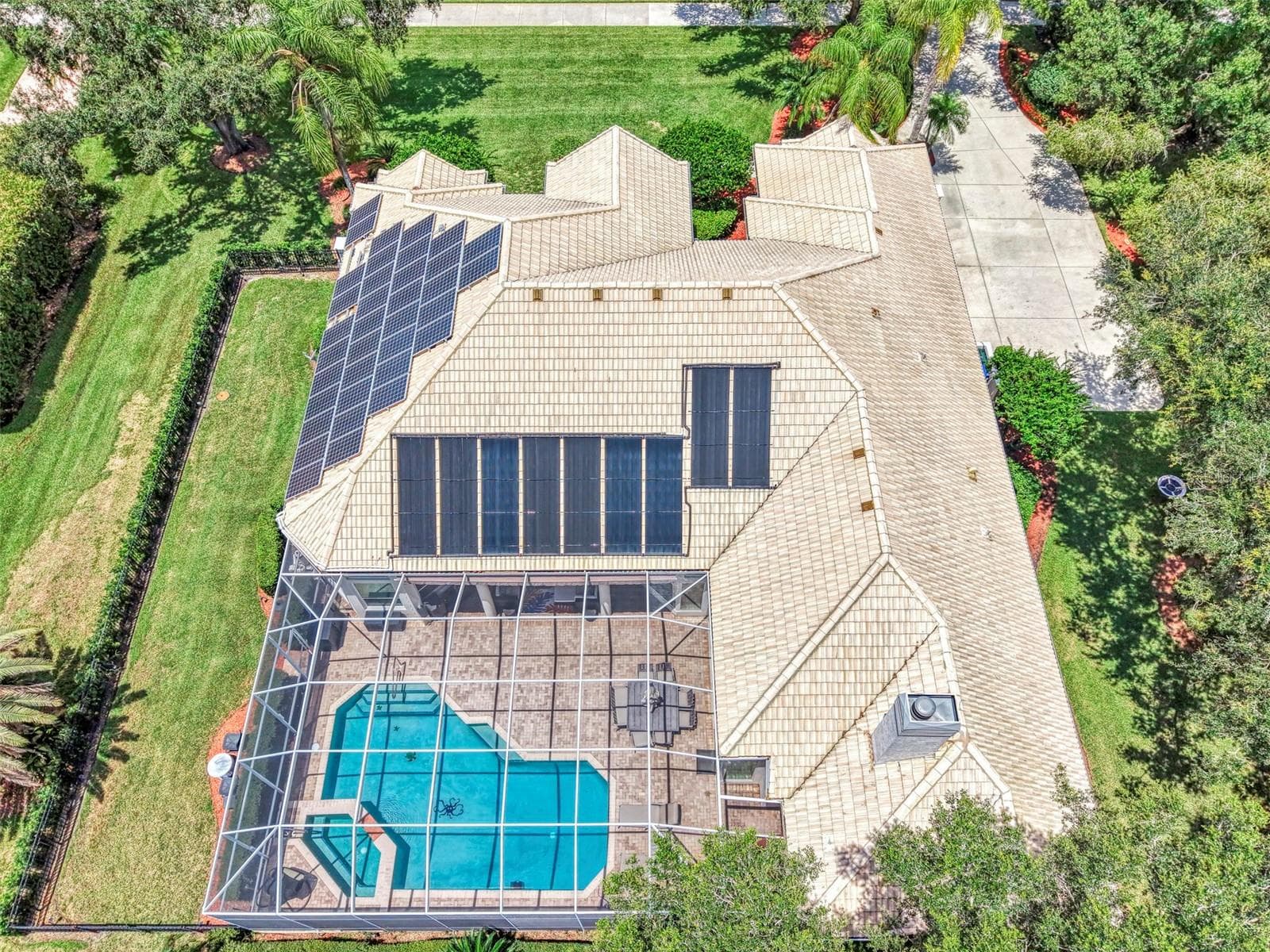 Overhead - fenced dog run on the left, and solar panels power the home, energy stored in Tesla Powerwall - 7767 ALISTER MACKENZIE DR, SARASOTA