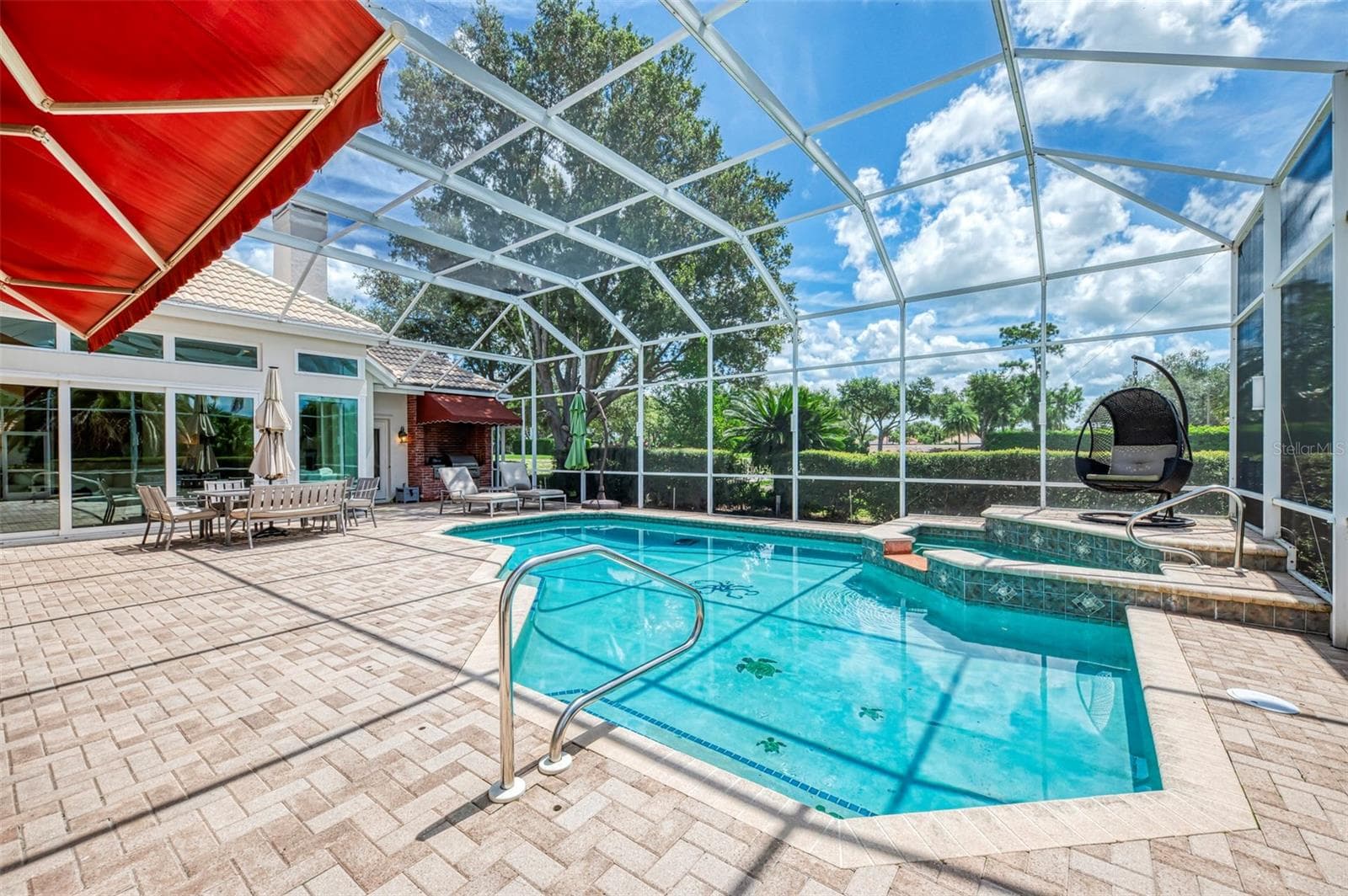 Heated saltwater pool and spa, solar and gas heated. Awning is retractable. - 7767 ALISTER MACKENZIE DR, SARASOTA