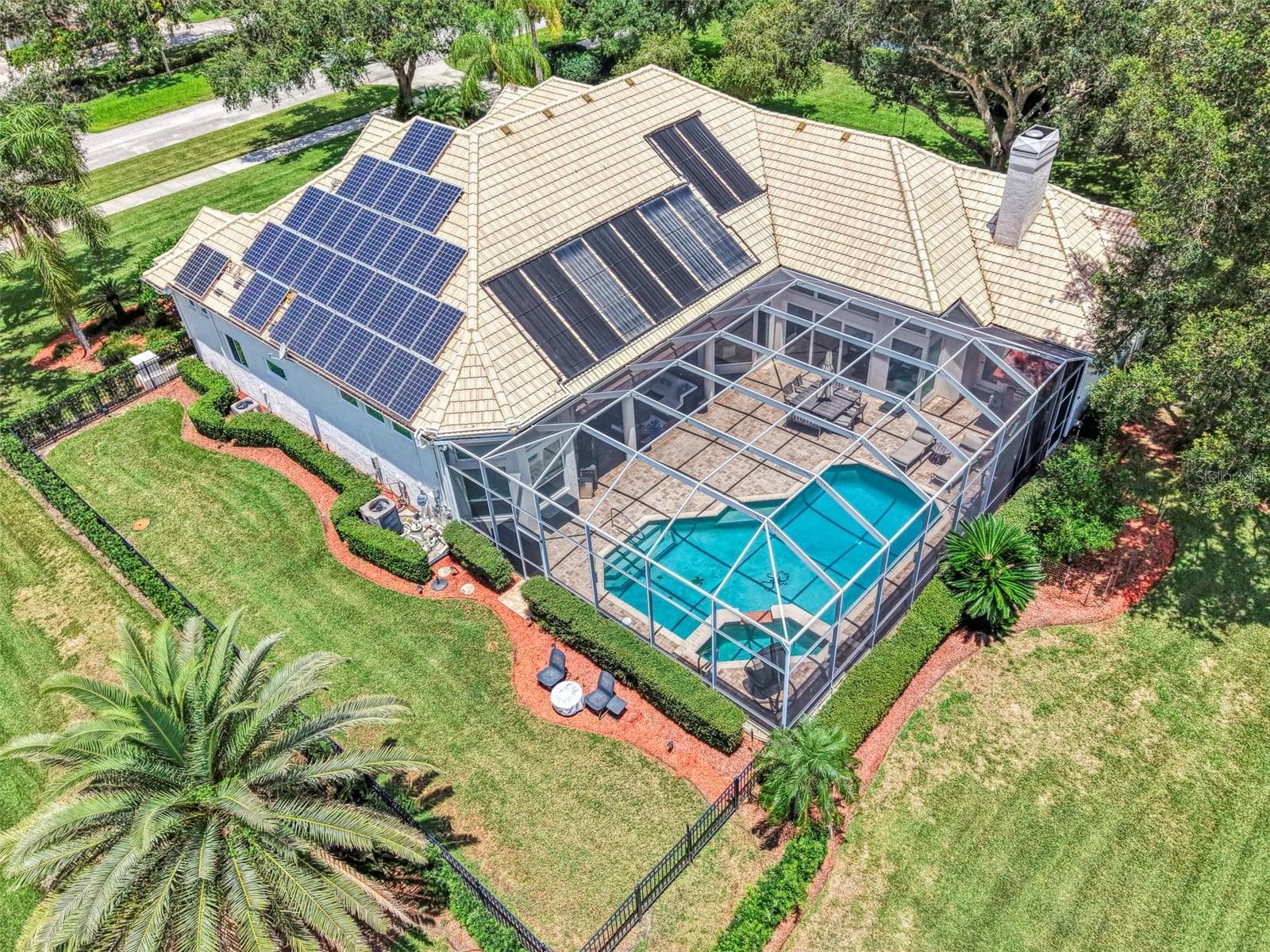Overhead - fenced dog run, and solar panels power the home, energy stored in Tesla Powerwall - 7767 ALISTER MACKENZIE DR, SARASOTA