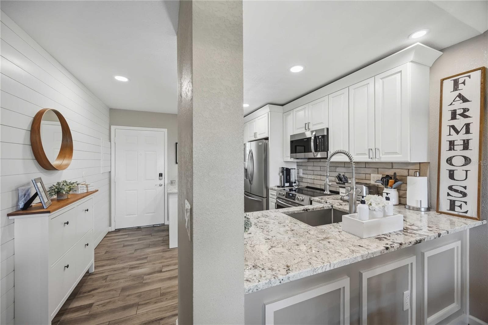 Spacious kitchen offers abundant cabinetry, granite countertops and stainless steel appliances. - 406 CERROMAR CIR N #328, VENICE