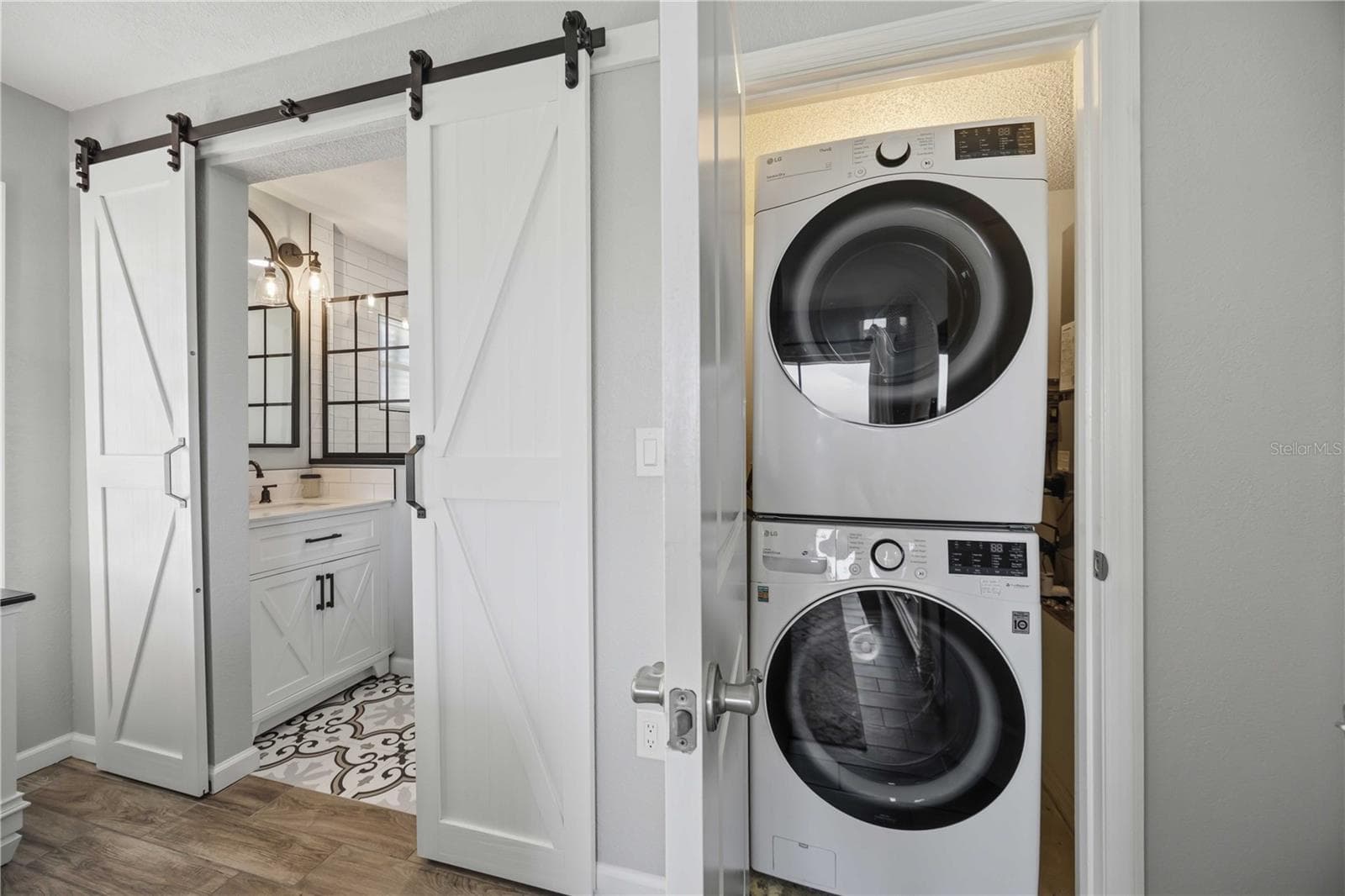 Stylish barn doors reveal the stunning bathroom. Closet with a convenient laundry area with stacked washer and dryer. - 406 CERROMAR CIR N #328, VENICE