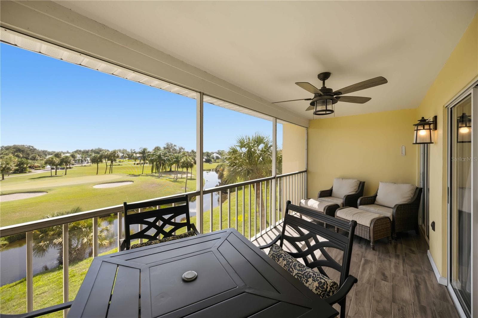 Covered and screened outdoor living makes it easy to enjoy the beautiful water and golf views throughout the day. - 406 CERROMAR CIR N #328, VENICE