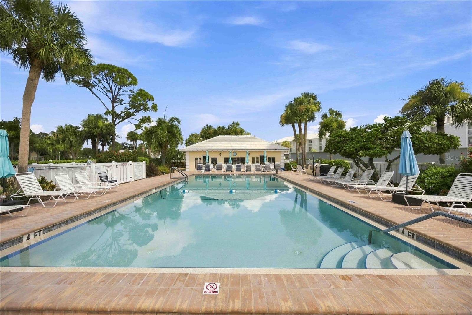 Sparkling community pool is surrounded by generous deck space, lounge seating and tropical scenery. - 406 CERROMAR CIR N #328, VENICE