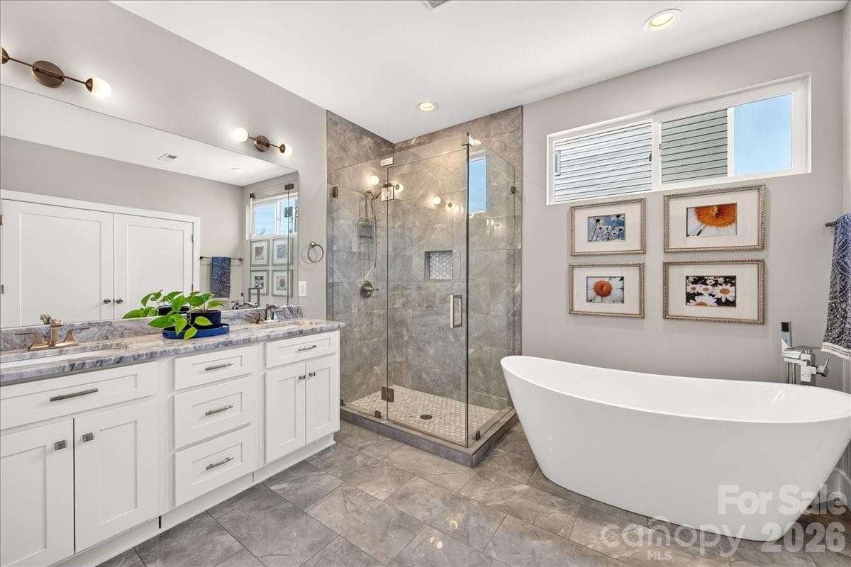 Beautiful primary bath with double sinks, walk-in shower and fabulous soaking tub - 621 Campus Street, Charlotte