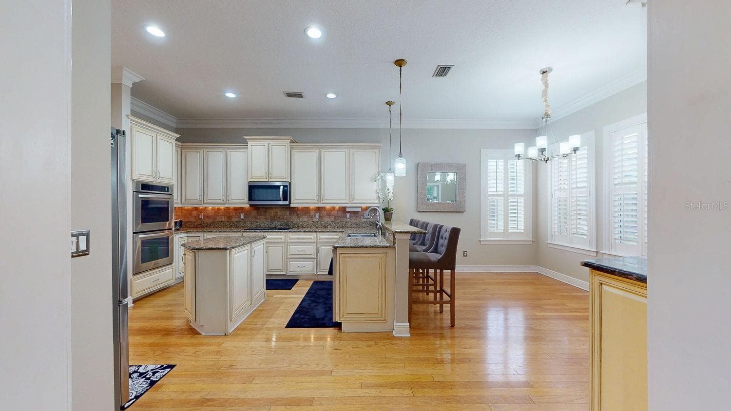 Side view of kitchen with incredible natural lighting and pool view - 116 S HESPERIDES ST, TAMPA