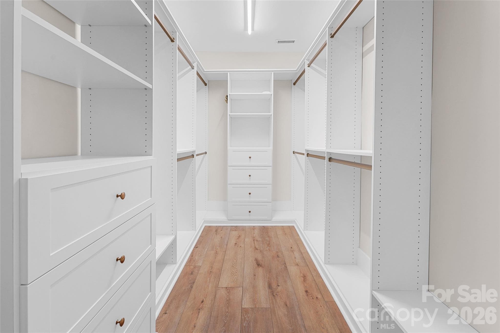 Custom closet built-ins maximize storage in the primary suite. - Charlotte