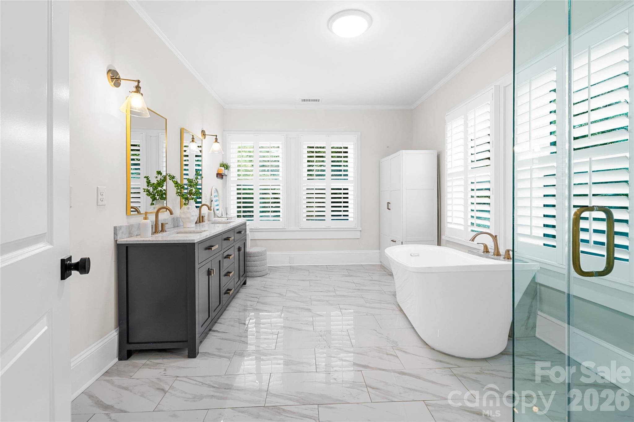 Fully renovated primary bath with a freestanding soaking tub. - Charlotte
