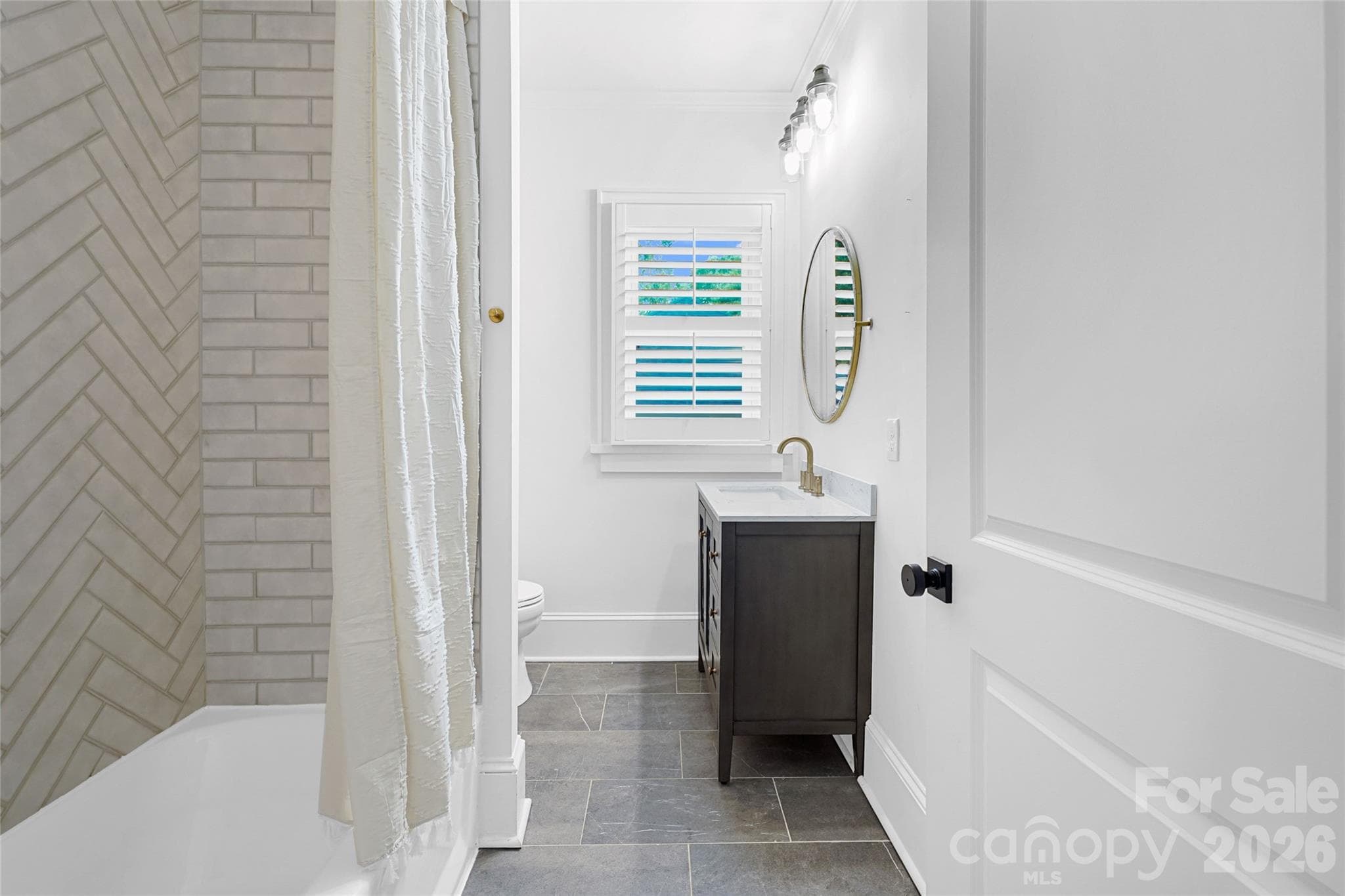 Updated secondary bath with timeless finishes. - Charlotte