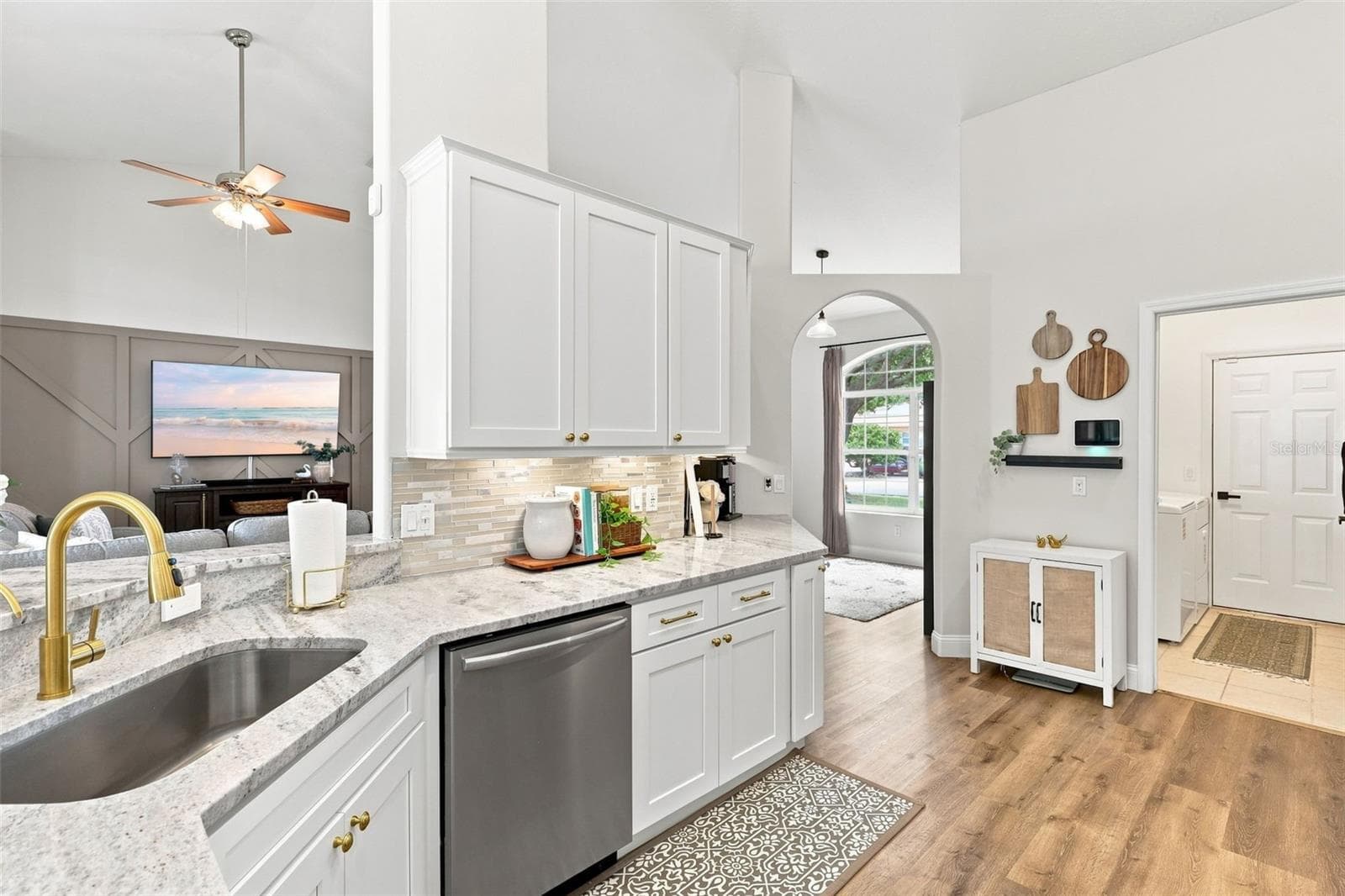 Remodeled kitchen towards indoor laundry room and garage at right. Open to main living area at left. - 96 PARKVIEW DR, PALM COAST