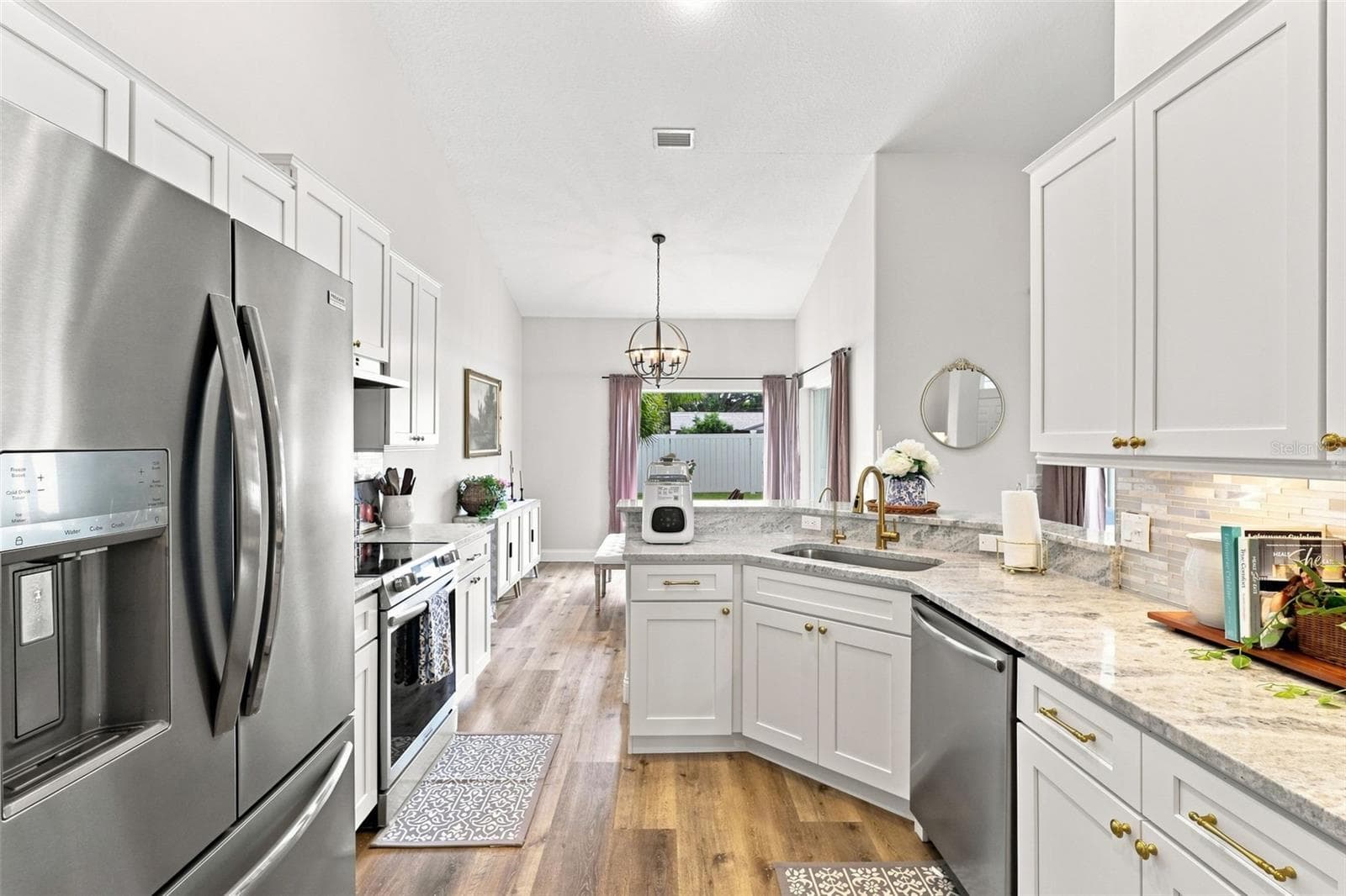 Updated kitchen with tons of soft-close cabinetry, stainless steel appliances and custom backsplash. - 96 PARKVIEW DR, PALM COAST