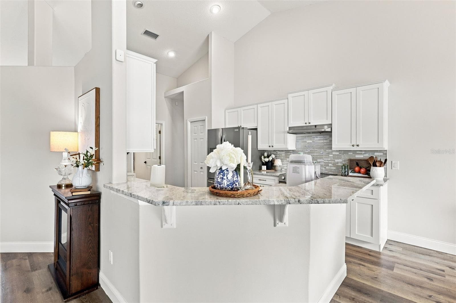 Breakfast bar with granite countertops. Kitchen remodel in 2026. - 96 PARKVIEW DR, PALM COAST