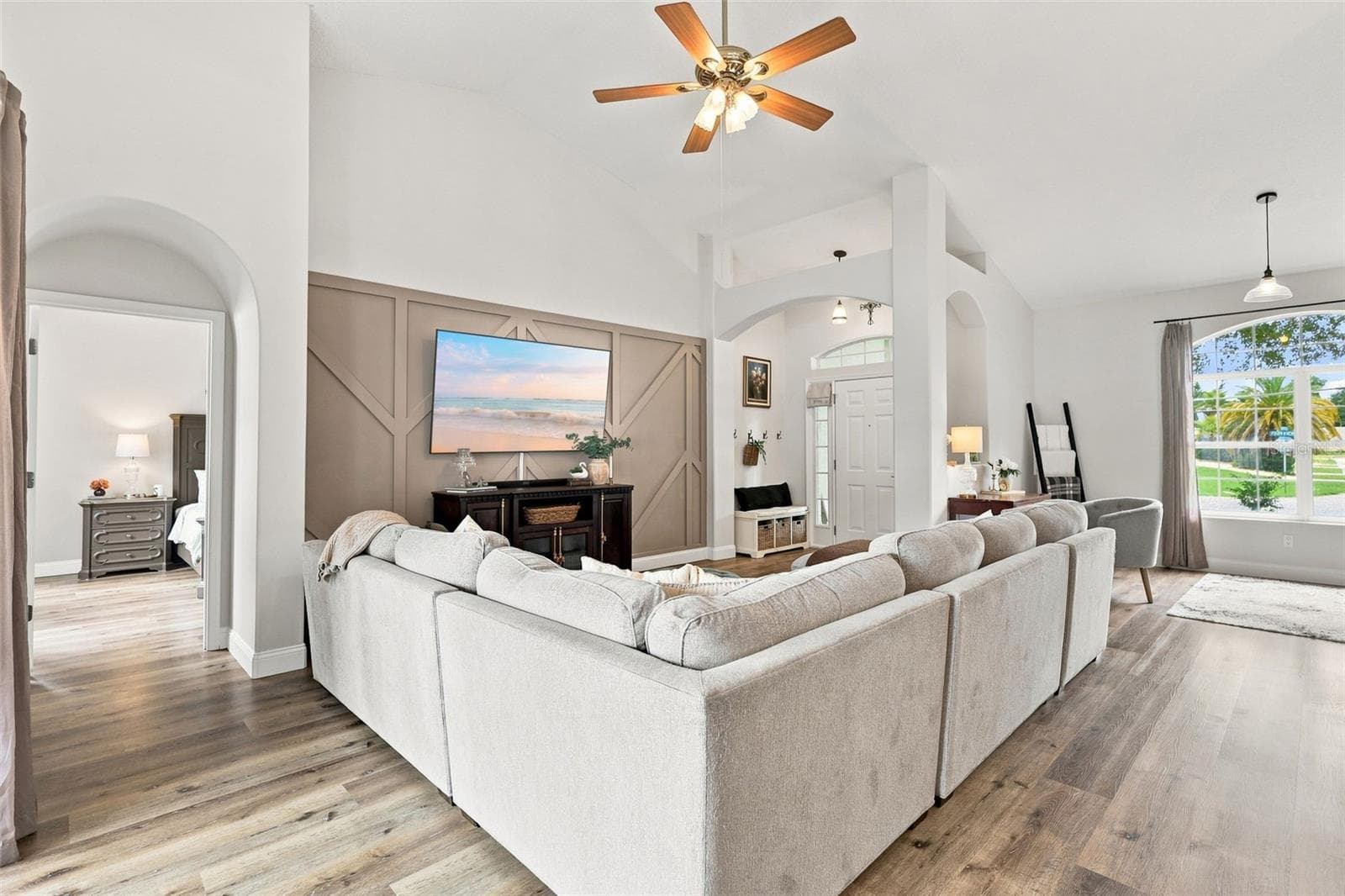 Main living area with primary bedroom suite at left. The soaring ceilings make this home feel even larger than it is. - 96 PARKVIEW DR, PALM COAST