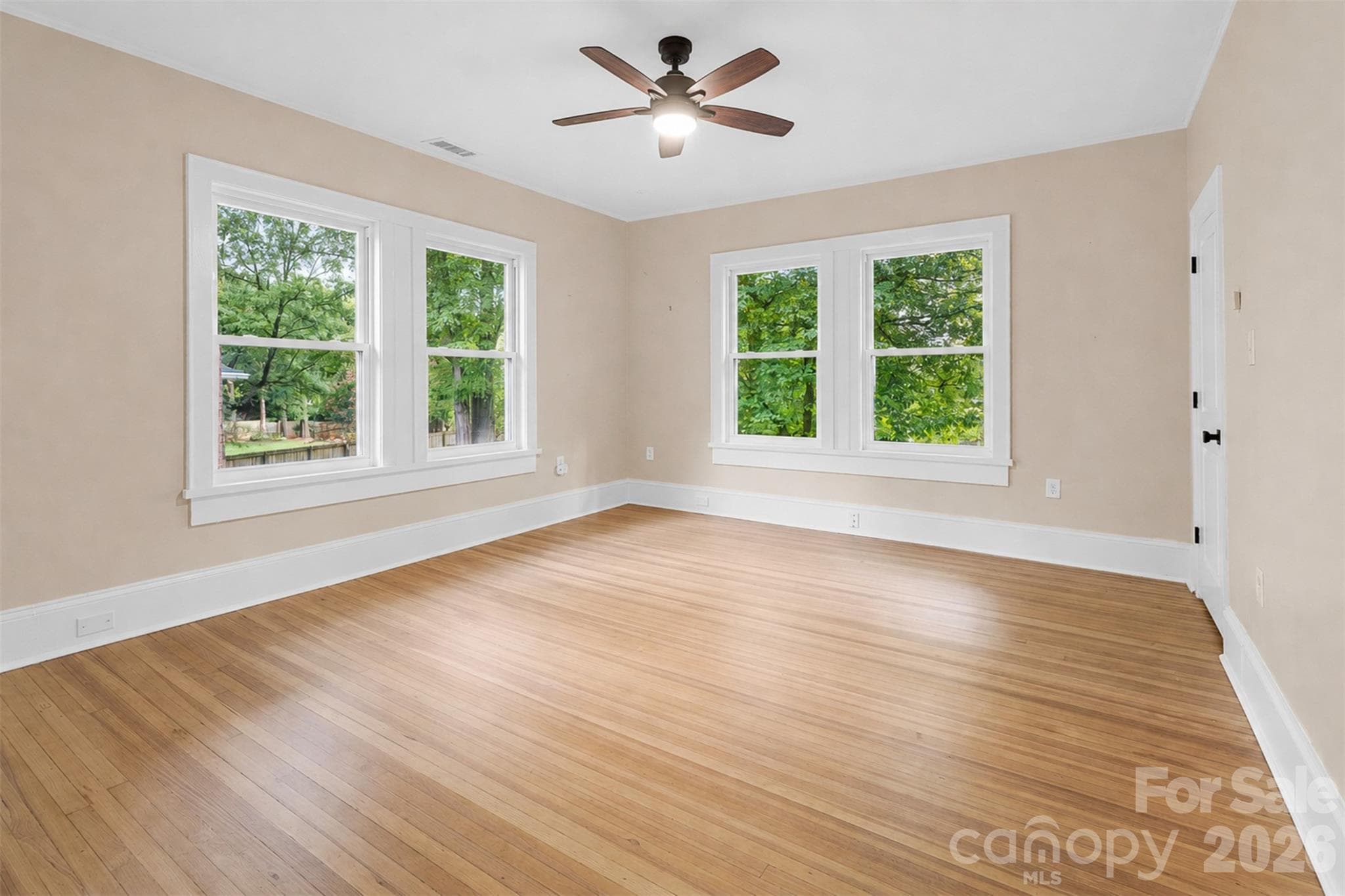 Generously sized secondary bedroom with hardwood floors. - Charlotte