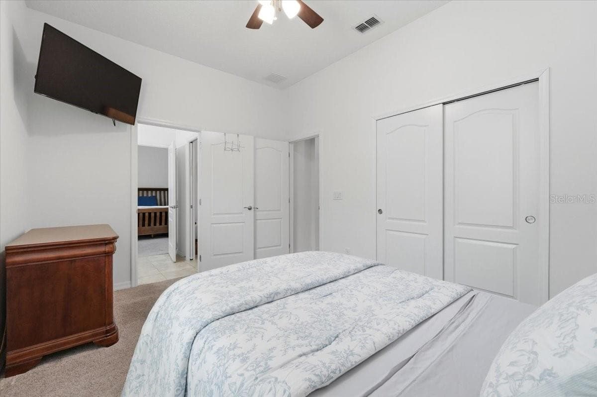 Bedroom 3 offers another well-proportioned space with generous closet storage and direct access to the shared Jack-and-Jill bath. - 4791 RIVERWALK DR, ST CLOUD