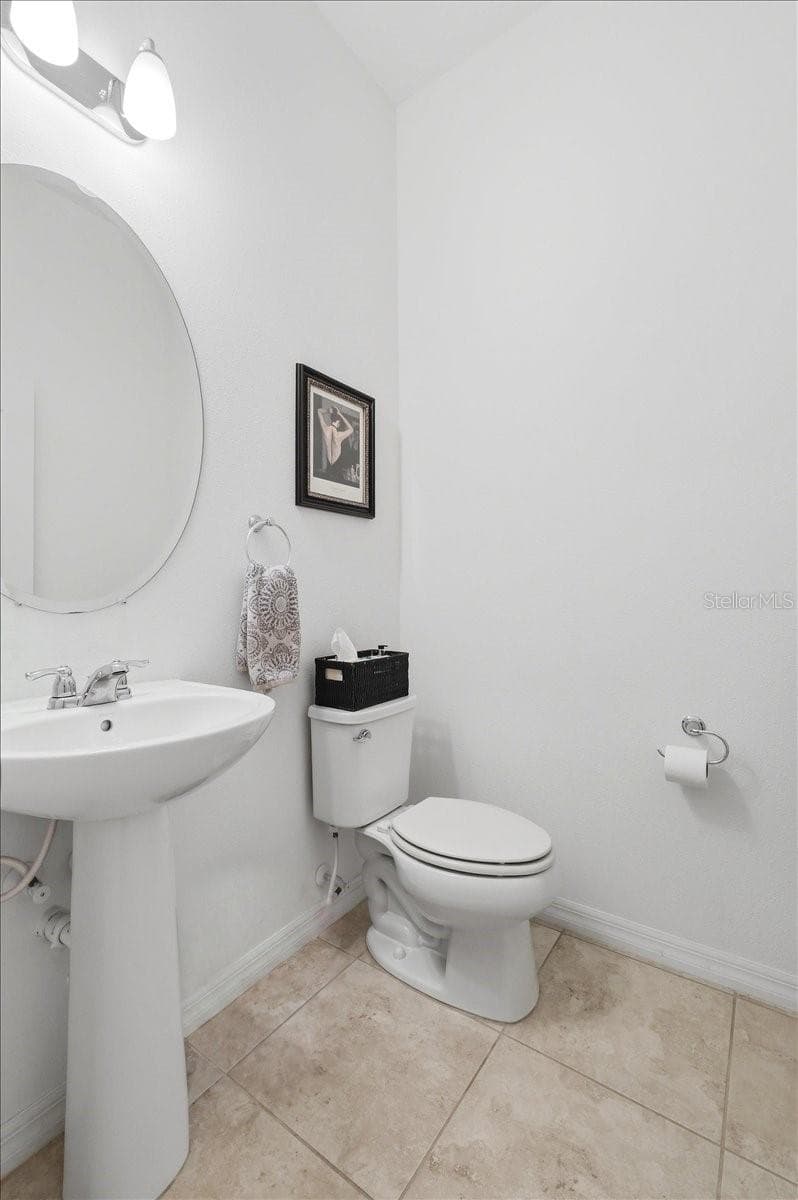 A conveniently located guest half bath adds a thoughtful touch for visitors while keeping the home’s private spaces separate. - 4791 RIVERWALK DR, ST CLOUD