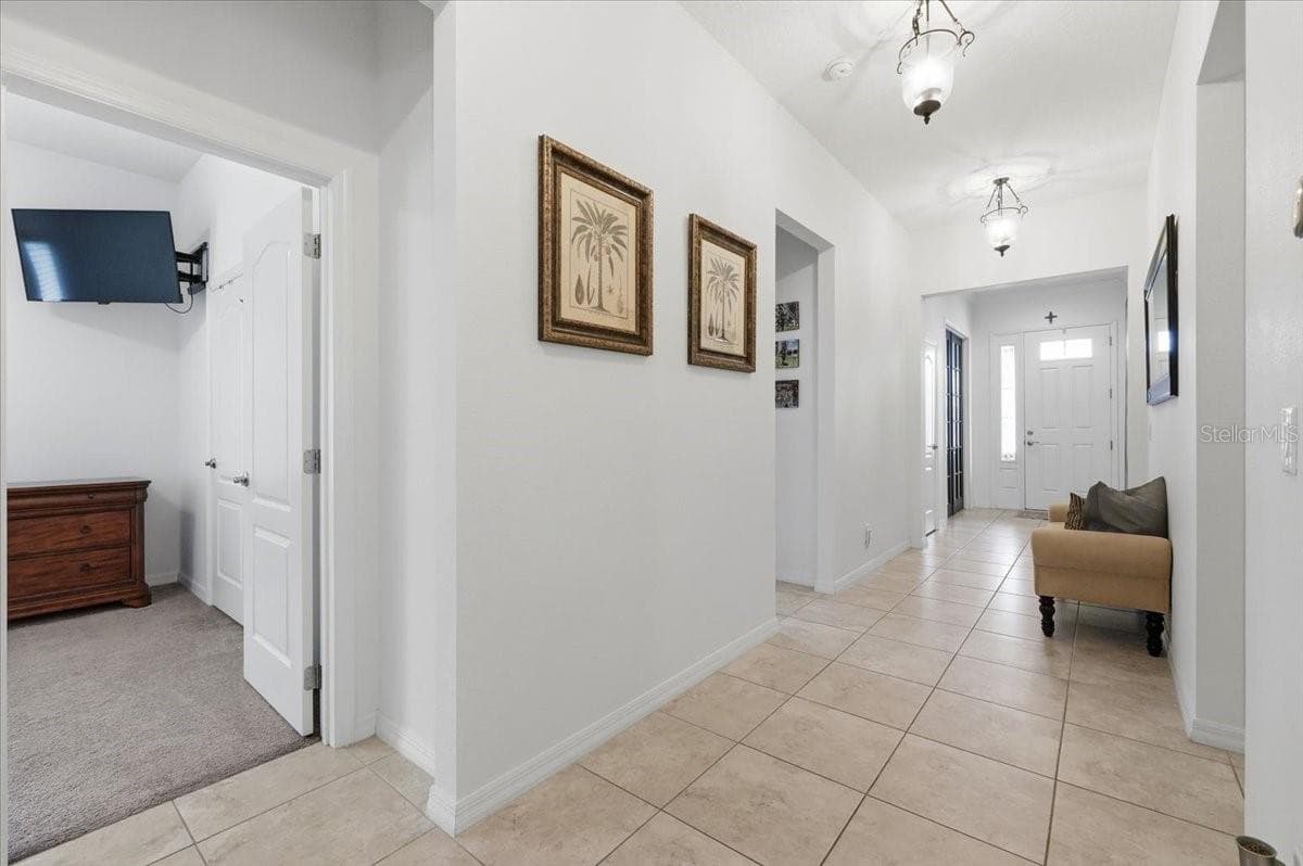 A remarkably wide hallway offers an airy sense of openness and easy flow throughout the home. - 4791 RIVERWALK DR, ST CLOUD