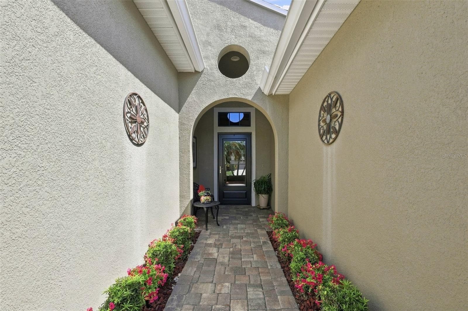 INTRODUCING THE FRONT ENTRY PAVER WALKWAY AND STORM DOOR. - 441 NOBLE FAIRE DR, SUN CITY CENTER