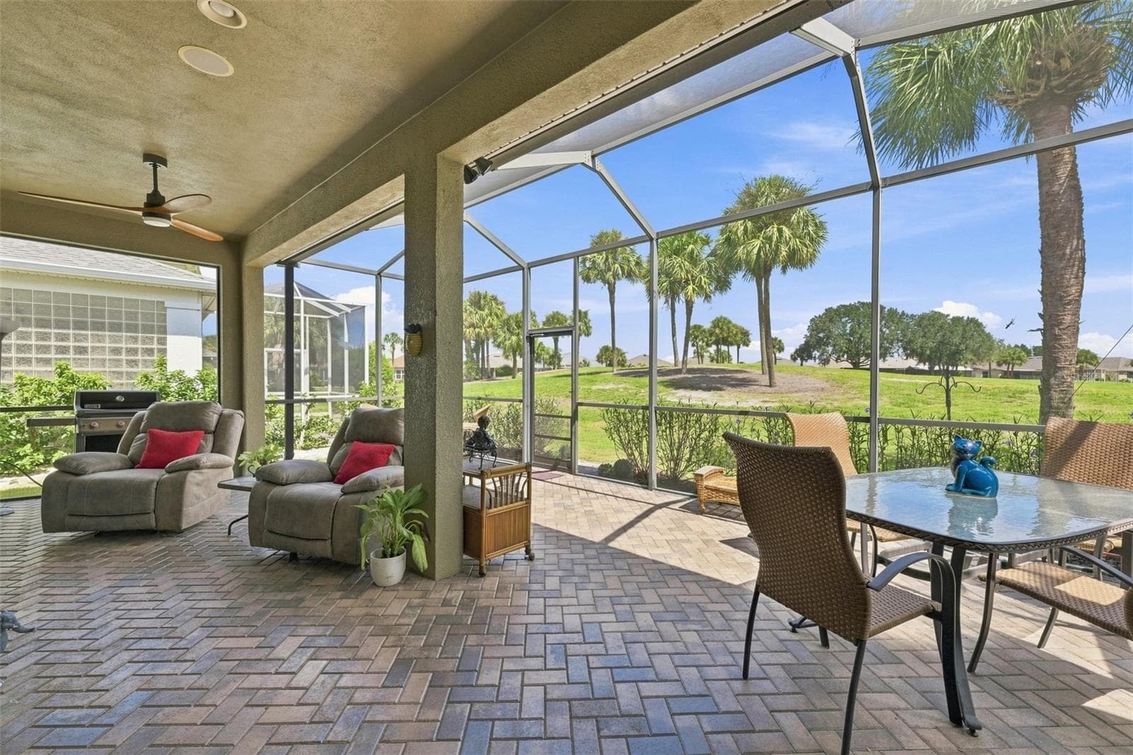 EXPANDED SCREENED LANAI WITH PAVERS.  WONDERFUL VIEW OF RENAISSANCE GOLF COURSE GREEN. - 441 NOBLE FAIRE DR, SUN CITY CENTER