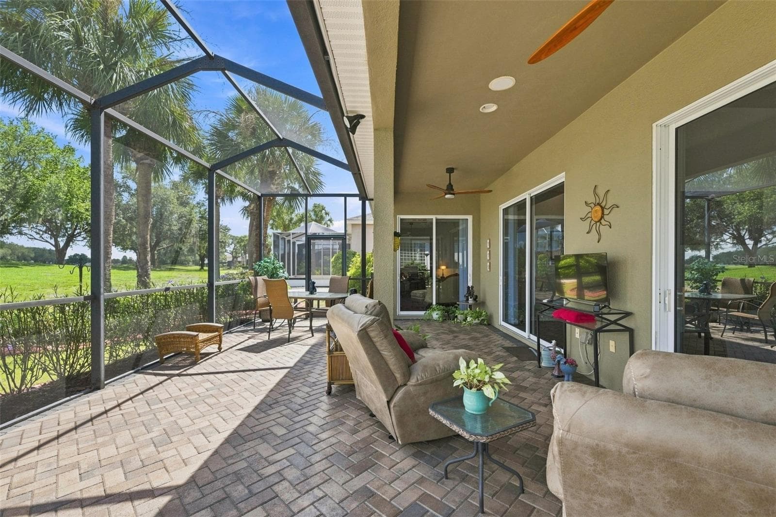 PLENTY OF SPACE FOR YOU TO ENJOY YOUR SREENED PAVERED PATIO.  RECLINE WHILE WATCHING YOUR FAVORITE SPORT.  NATURAL GAS HOOKUP FOR YOUR BBQ IF YOU PLEASE. - 441 NOBLE FAIRE DR, SUN CITY CENTER