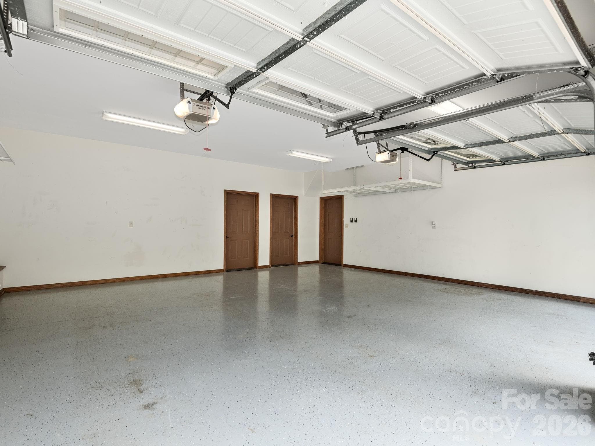 Lower Level two car garage. Door to interior basement, storage room and large mechanical room. - 248 Wisdom Cove Road, Flat Rock