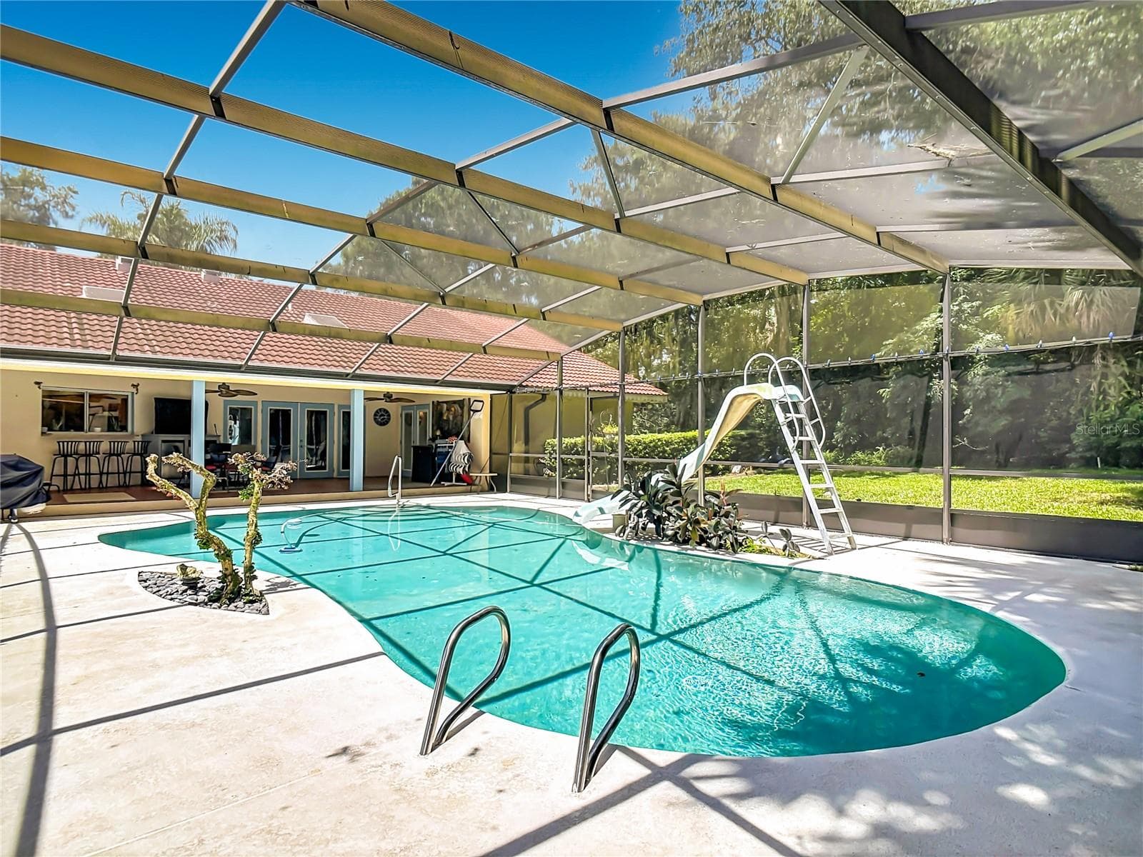 screened in ground pool with slide - 2269 COUNTRY CLUB DR, DELAND