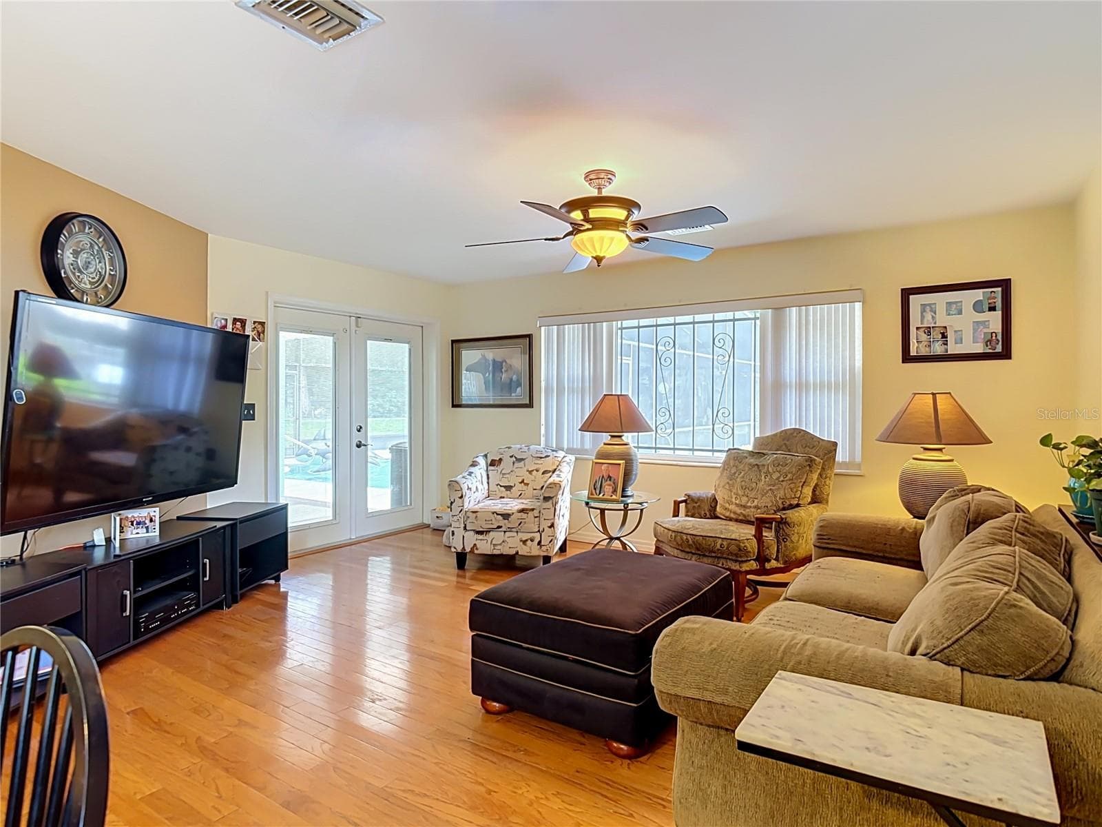 living room with french doors to the screened lanai and pool - 2269 COUNTRY CLUB DR, DELAND