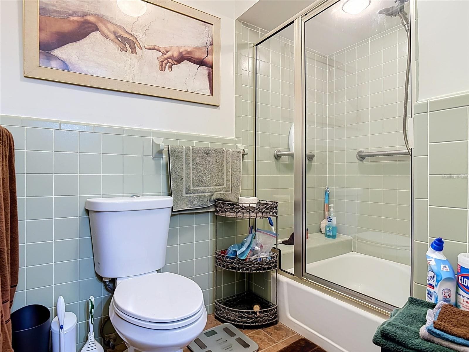 primary en suite bathroom with trendy original light green tile in excellent condition. - 2269 COUNTRY CLUB DR, DELAND