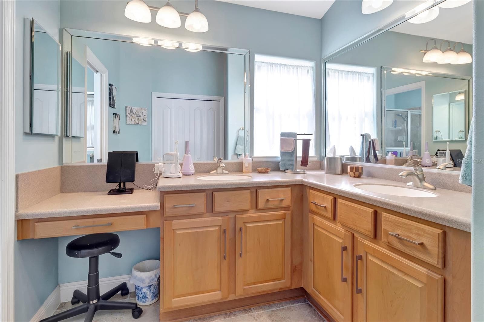 Solid surface counters in primary bathroom and added make up counter and large mirrors. - 4190 COUNTY ROAD 121D, WILDWOOD
