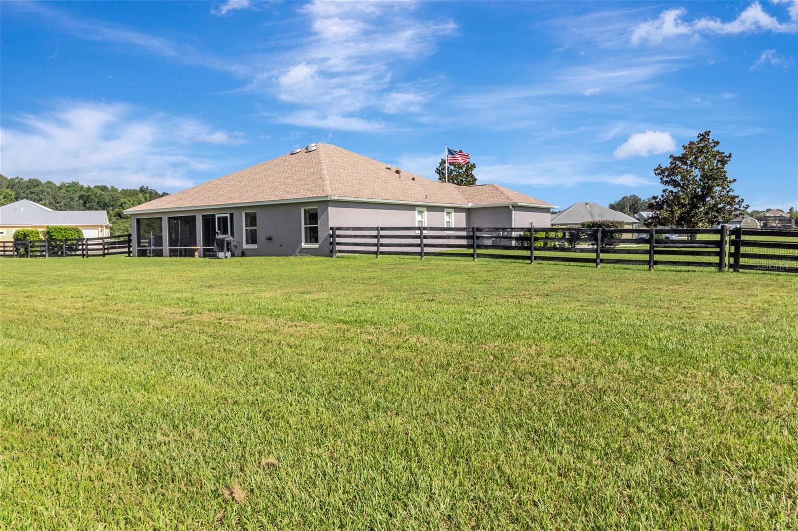Gate for easy access to the garage out behind the home. You will be the envy of your neighbors with this garage!! - 4190 COUNTY ROAD 121D, WILDWOOD