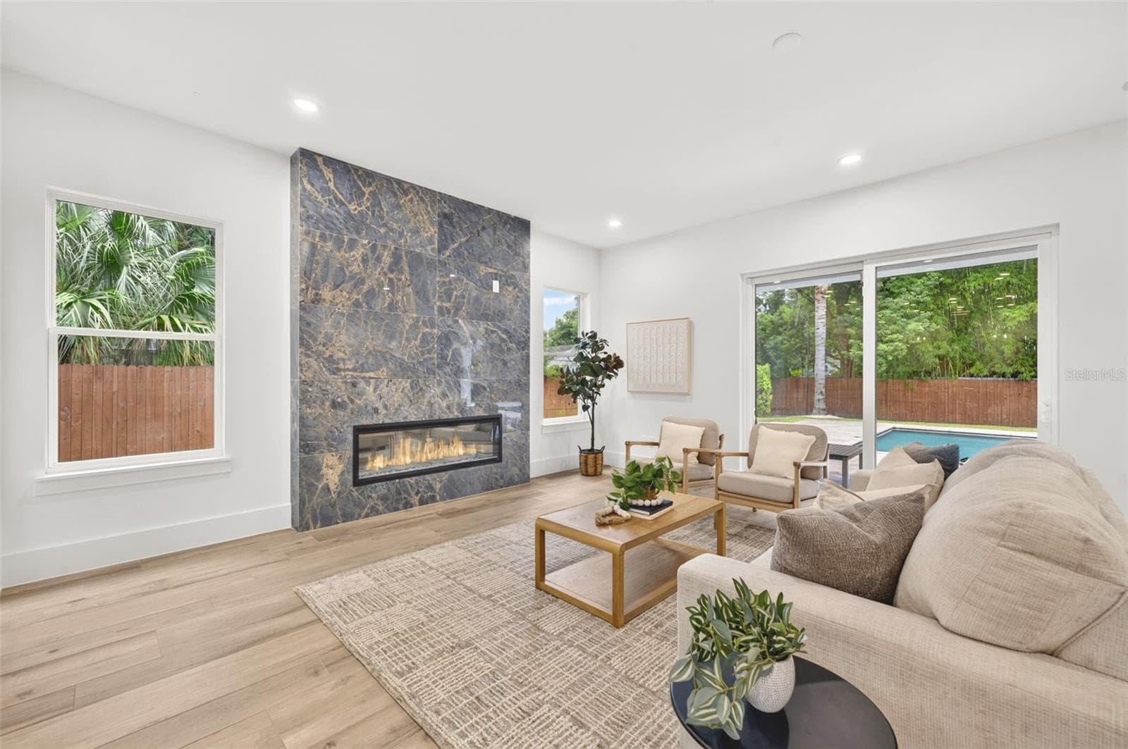 Living room with custom-built fireplace & stylish tile surround - 2343 VERSAILLES AVE, WINTER PARK