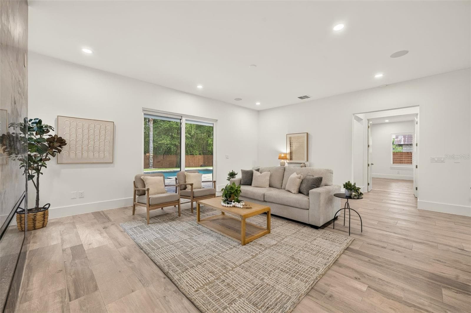 Living room with sliding glass doors to the covered lanai & pool - 2343 VERSAILLES AVE, WINTER PARK