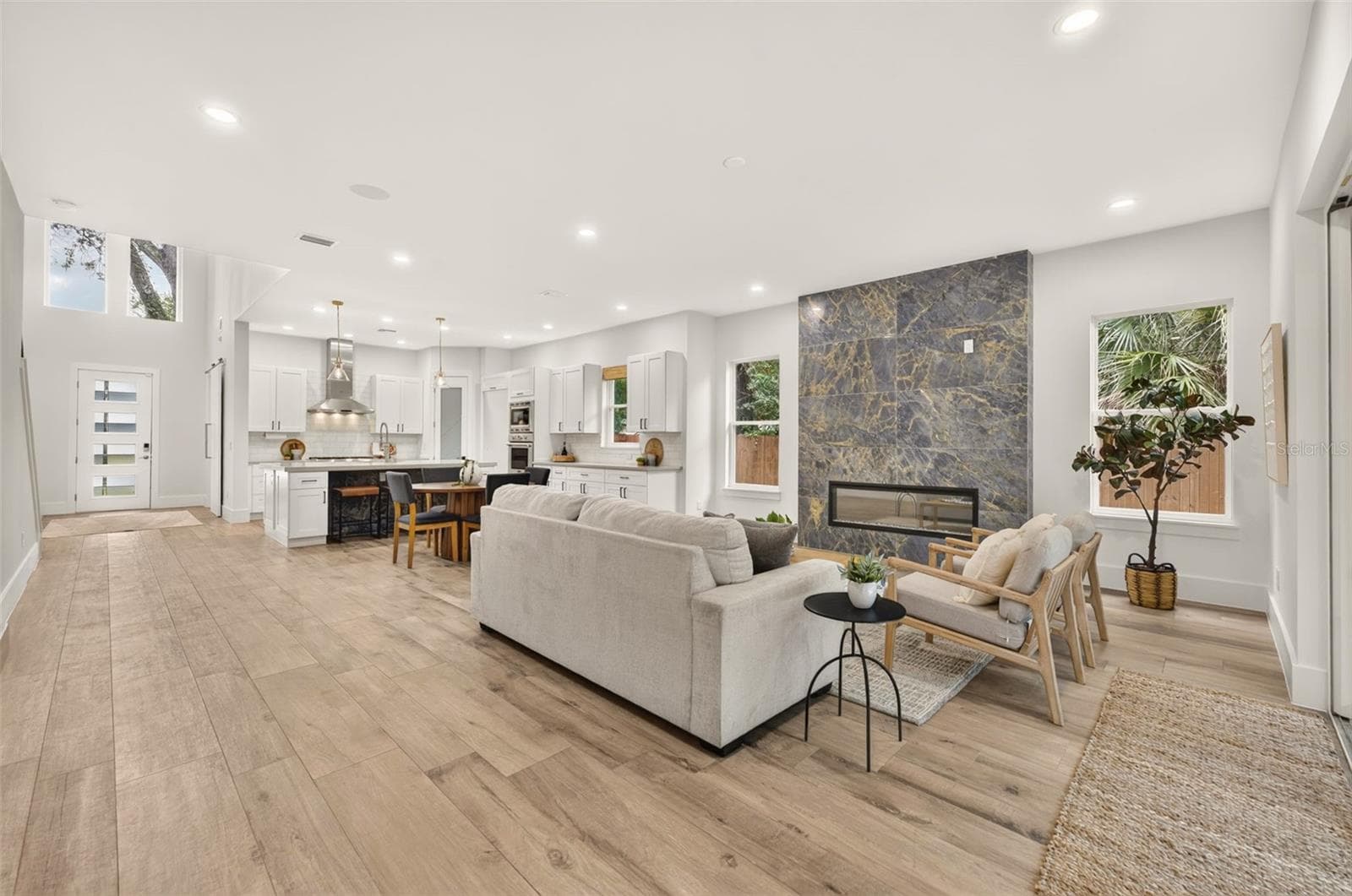 Washed oak porcelain plank tile flooring throughout the 1st floor - 2343 VERSAILLES AVE, WINTER PARK