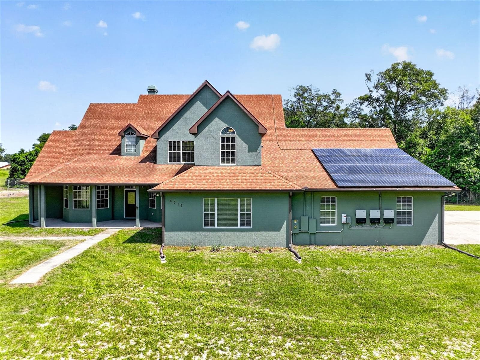Classic architectural details meet modern energy efficiency with an owned solar panel system. - 4617 ROUND LAKE RD, APOPKA