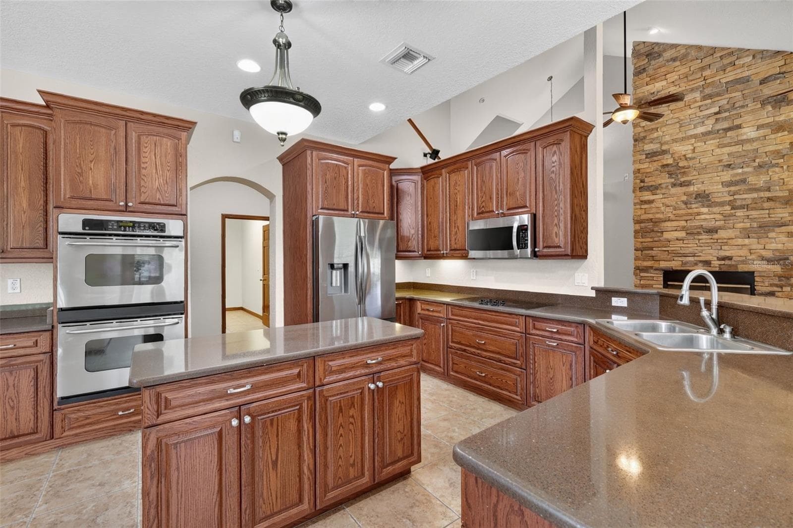 From every angle, this kitchen impresses with its scale, storage, and seamless connection to the home's main living spaces - 4617 ROUND LAKE RD, APOPKA