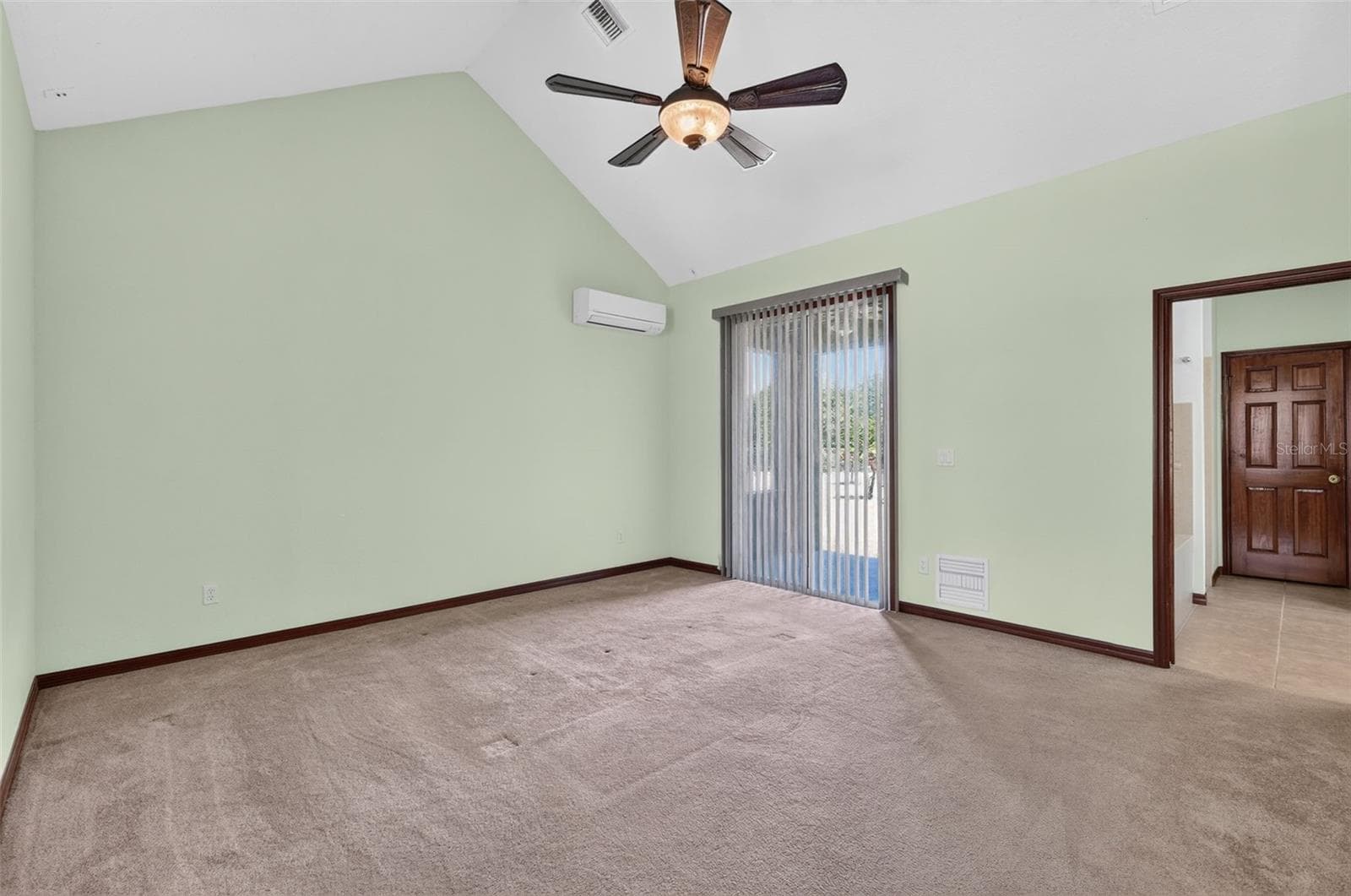The primary suite is a true retreat with soaring vaulted ceilings, a private patio entrance, and its own climate-controlled comfort. - 4617 ROUND LAKE RD, APOPKA