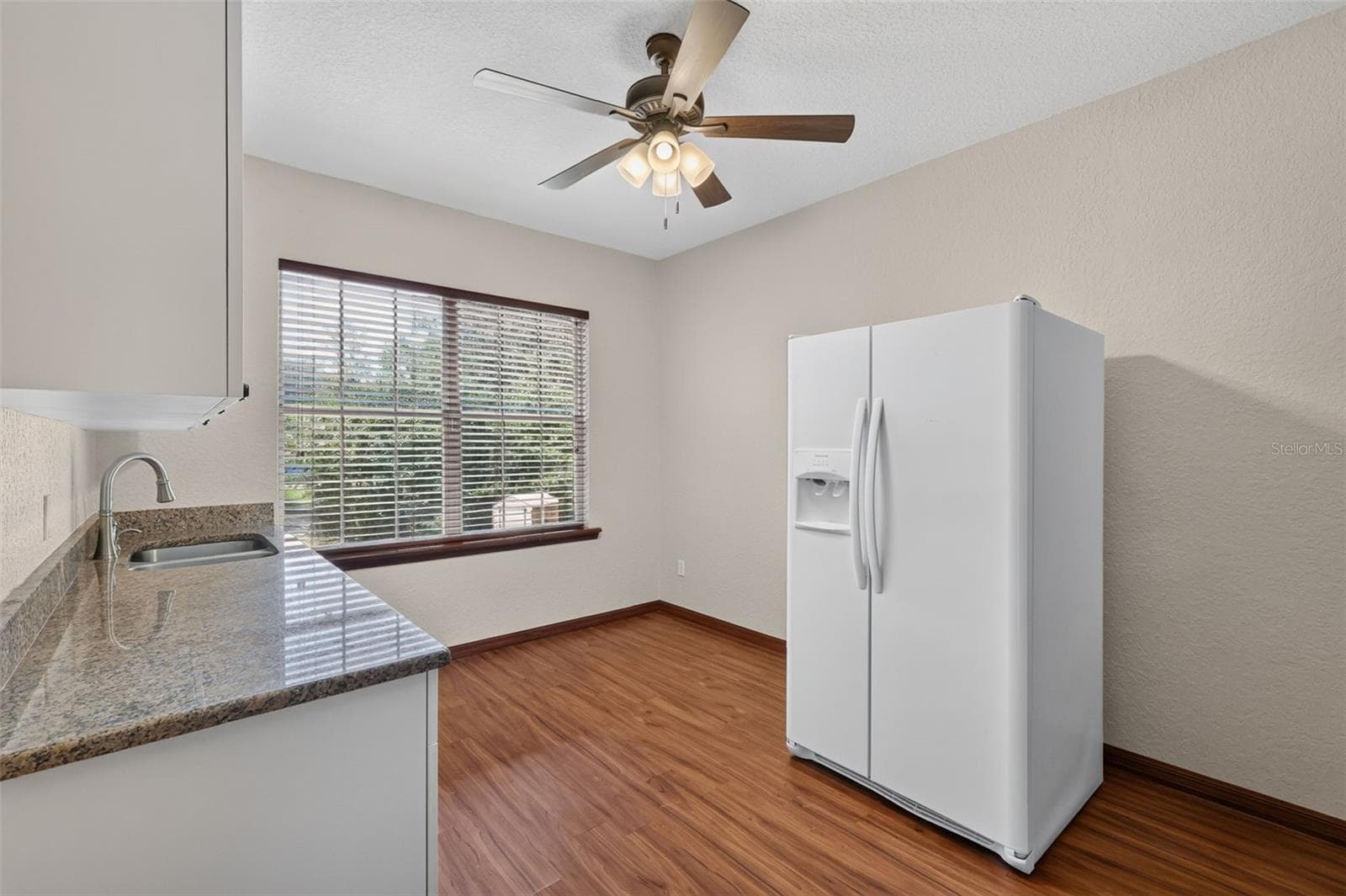 The second kitchen space offers a full-size fridge, natural light, and all the essentials for independent living. - 4617 ROUND LAKE RD, APOPKA