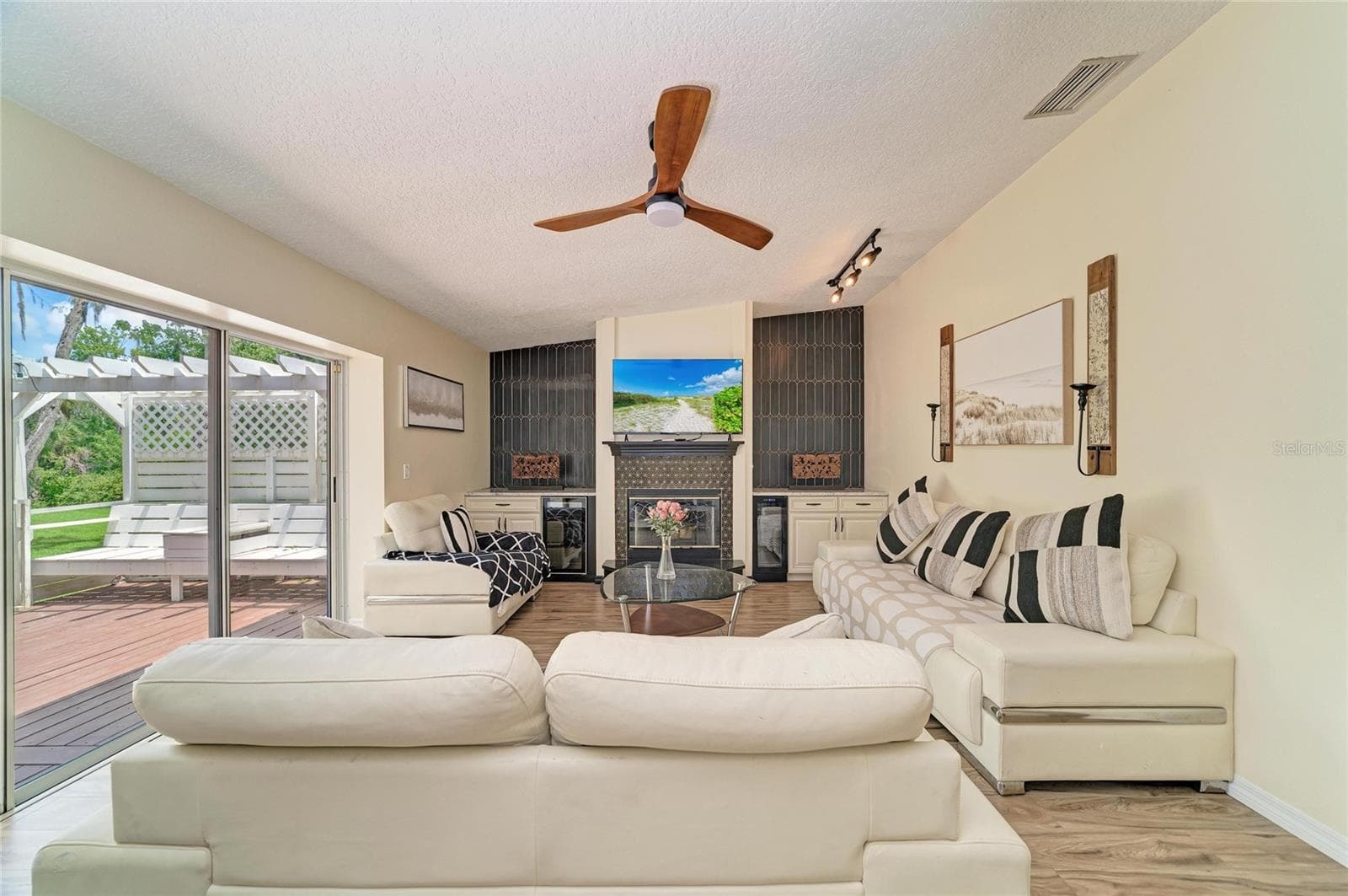 Family room with fireplace, built-in cabinetry, and two mini-fridges. - 6519 28TH AVE E, BRADENTON