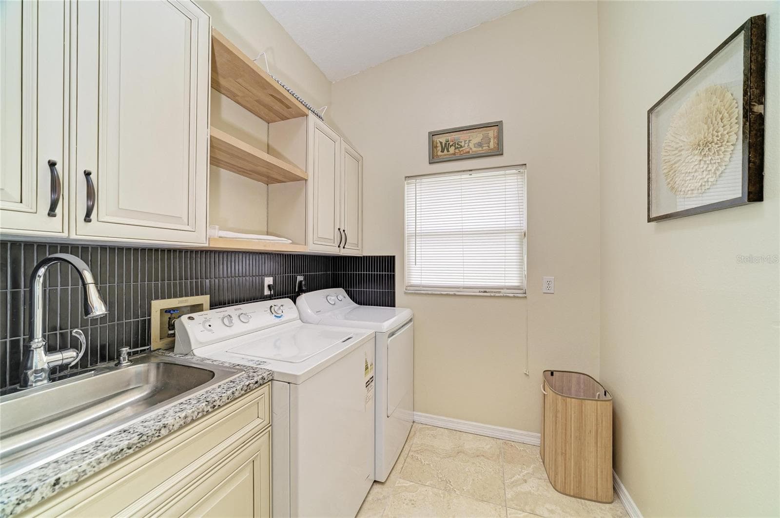1st floor Laundry Room with sink and cabinetry. - 6519 28TH AVE E, BRADENTON