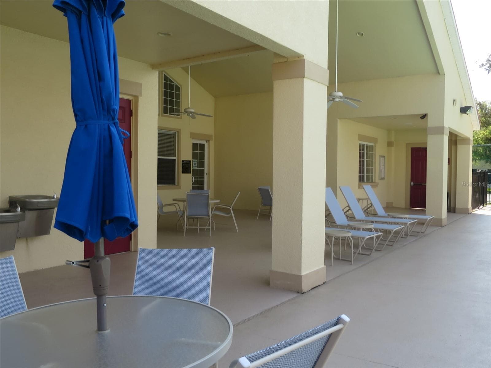 Community Clubhouse exterior resting area by the Pool - 2806 CLUB CORTILE CIR #B, KISSIMMEE