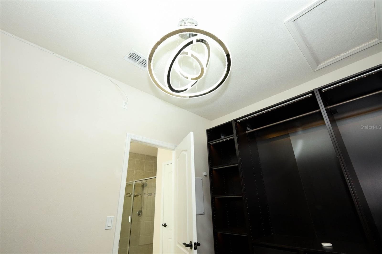 CRYSTAL CHANDELIER IN MASTER CLOSET - 12397 STONE BARK TRL, ORLANDO