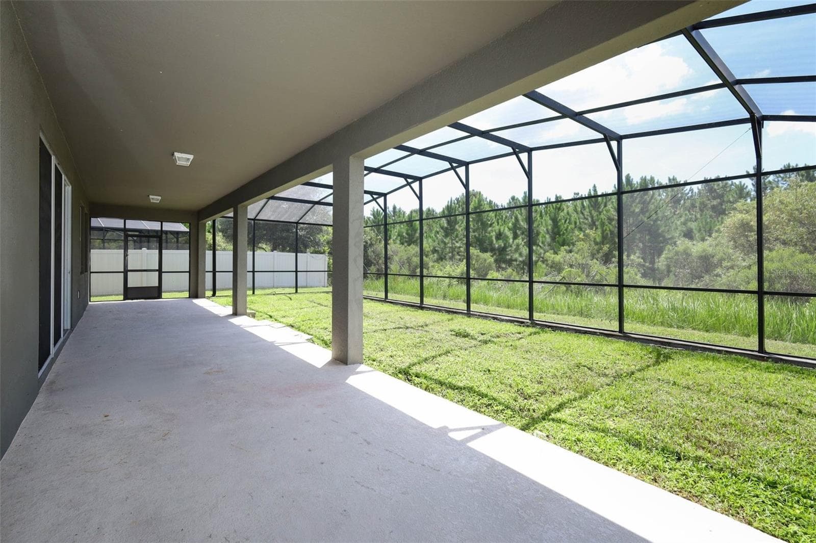 lanai featuring a large, open-concept living space. - 12397 STONE BARK TRL, ORLANDO